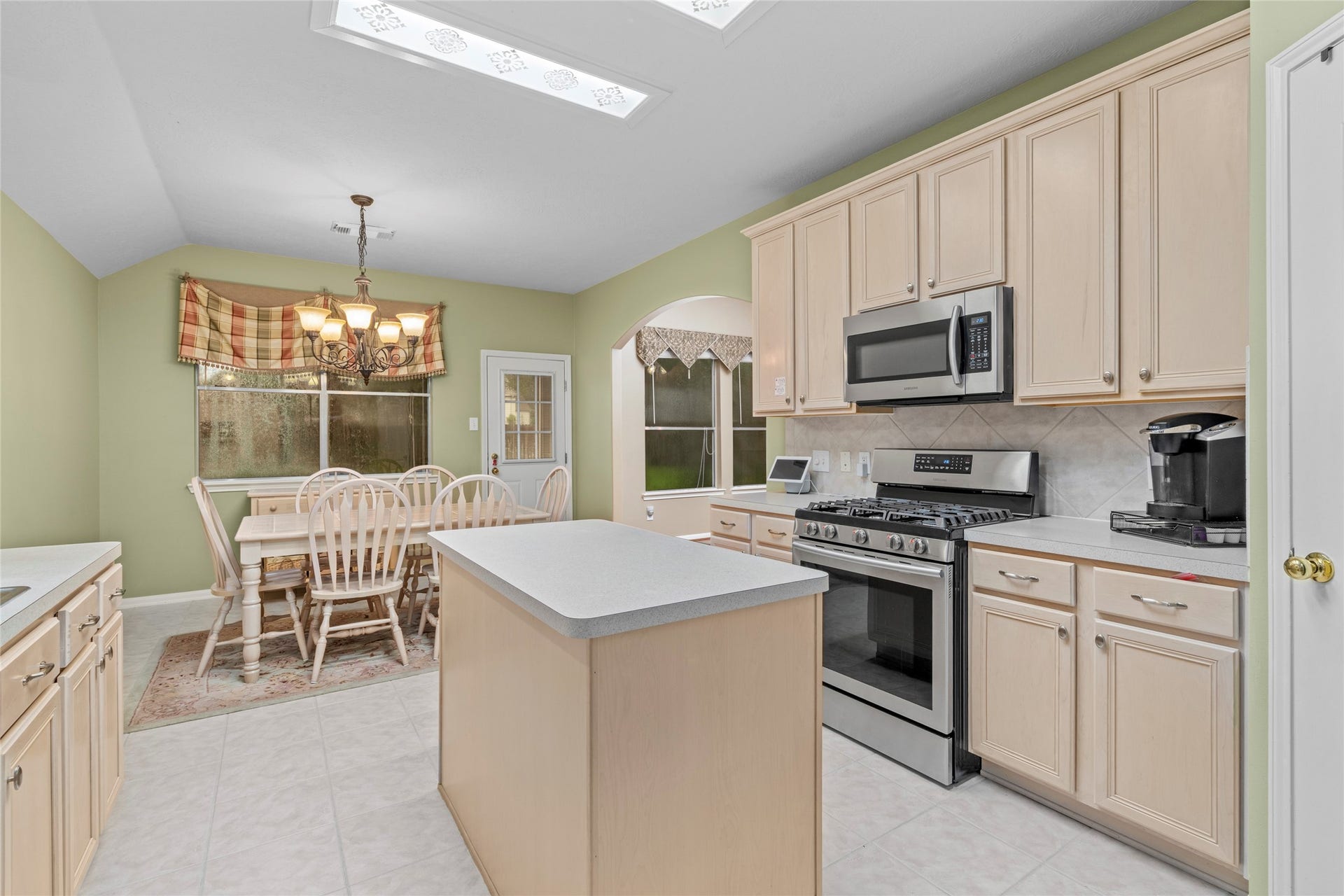 Kitchen and dining areas come together in a comfortable arrangement designed around everyday living. The dedicated dining space and open kitchen layout make it easy to imagine both quick weekday meals and larger gatherings.