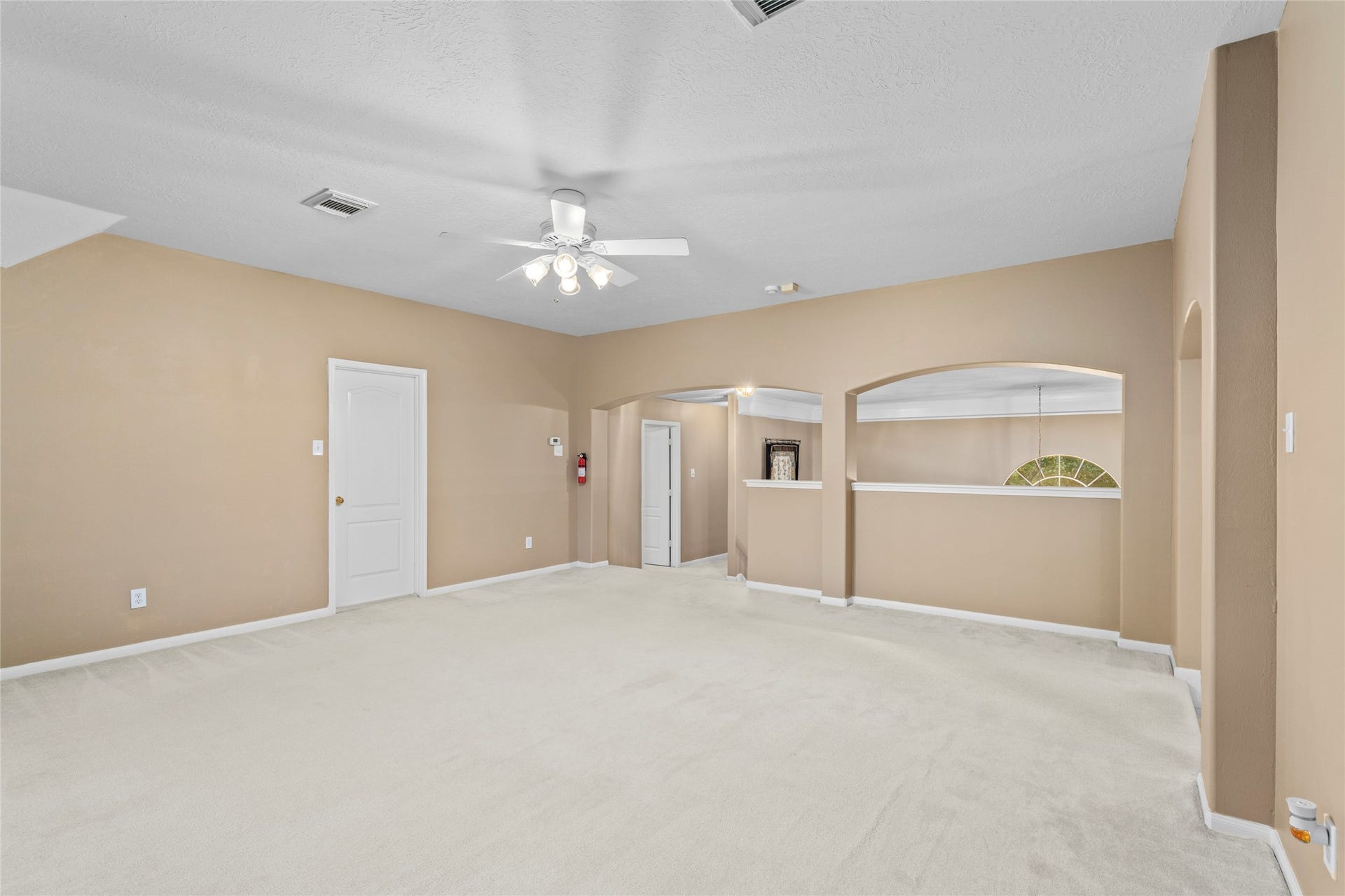 Another view of the spacious upstairs living area/game room emphasizes its generous scale and open architectural character. With room to configure seating, media, hobbies, or family activities, this space adds valuable versatility to the floor plan.