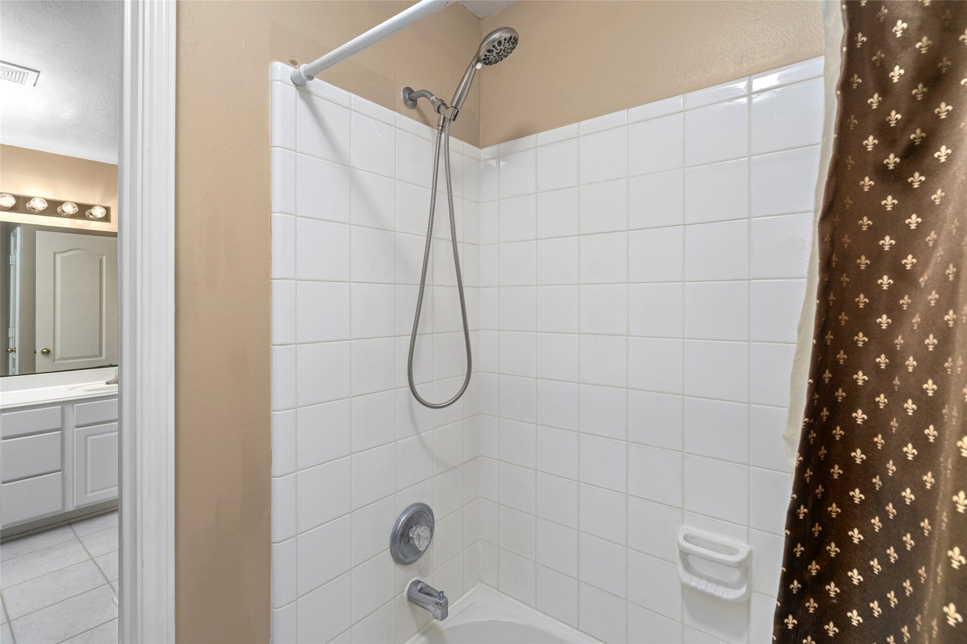 Bright full bathroom with classic tub/shower combination and generous vanity space. The clean, versatile layout is well suited to family use and provides a practical bathroom option for the secondary bedrooms.