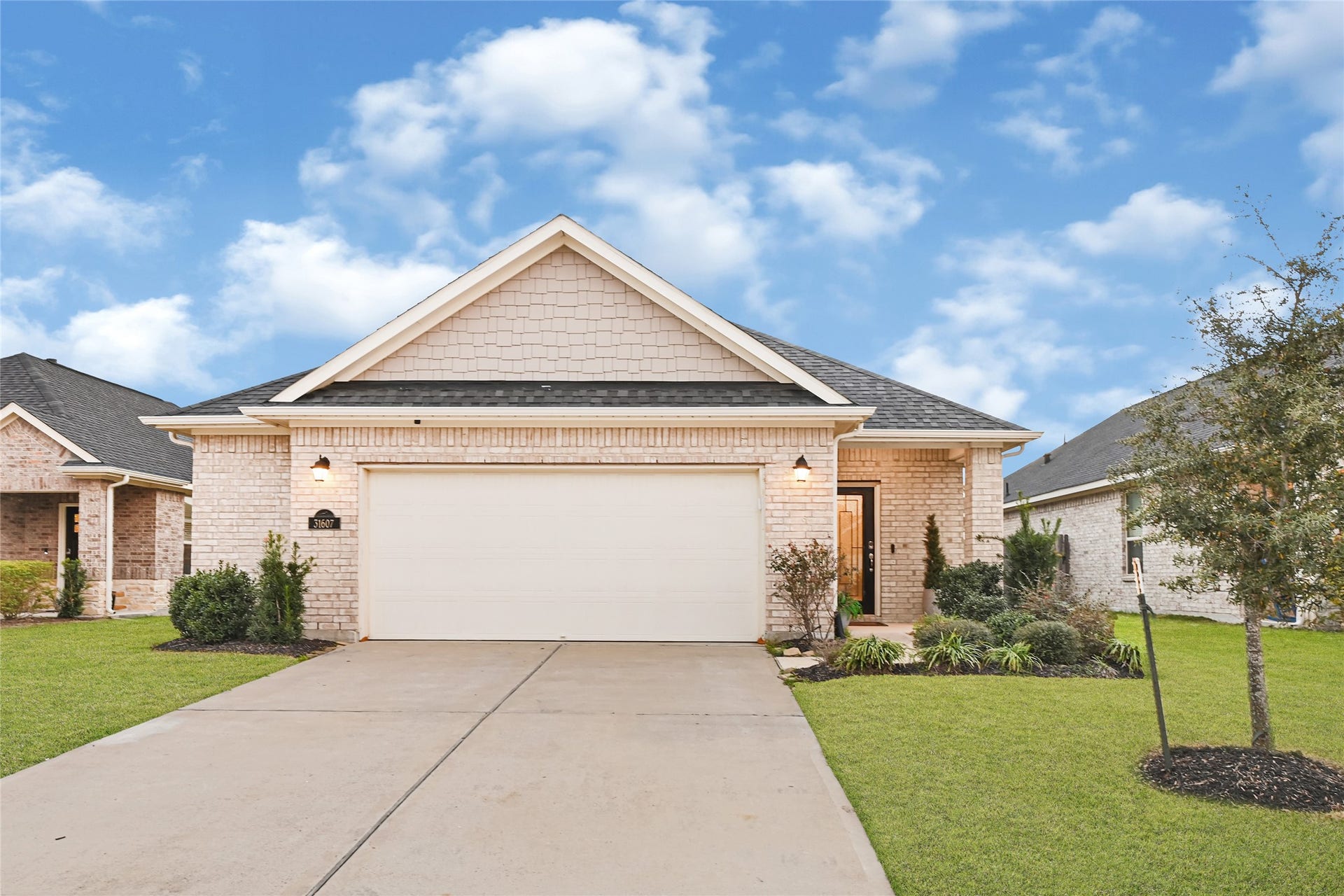 31607 Eldorado Lane, Fulshear, TX 77441 Large driveway and garage with additional sotrage space.