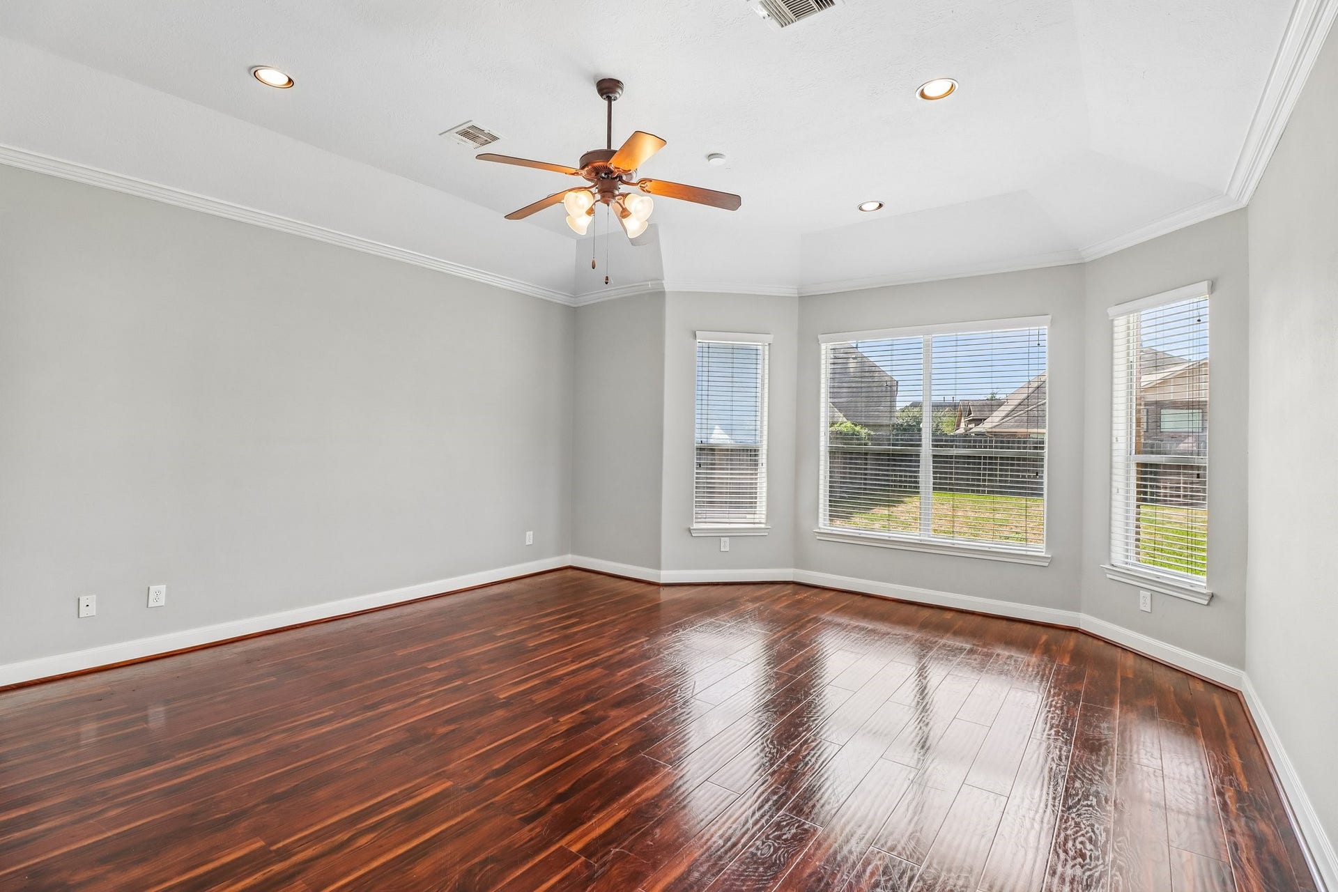 22715 Wilbur Lane, Tomball, TX 77375 Bright room with neutral walls, crown molding, and a ceiling fan, featuring elegant tile flooring.