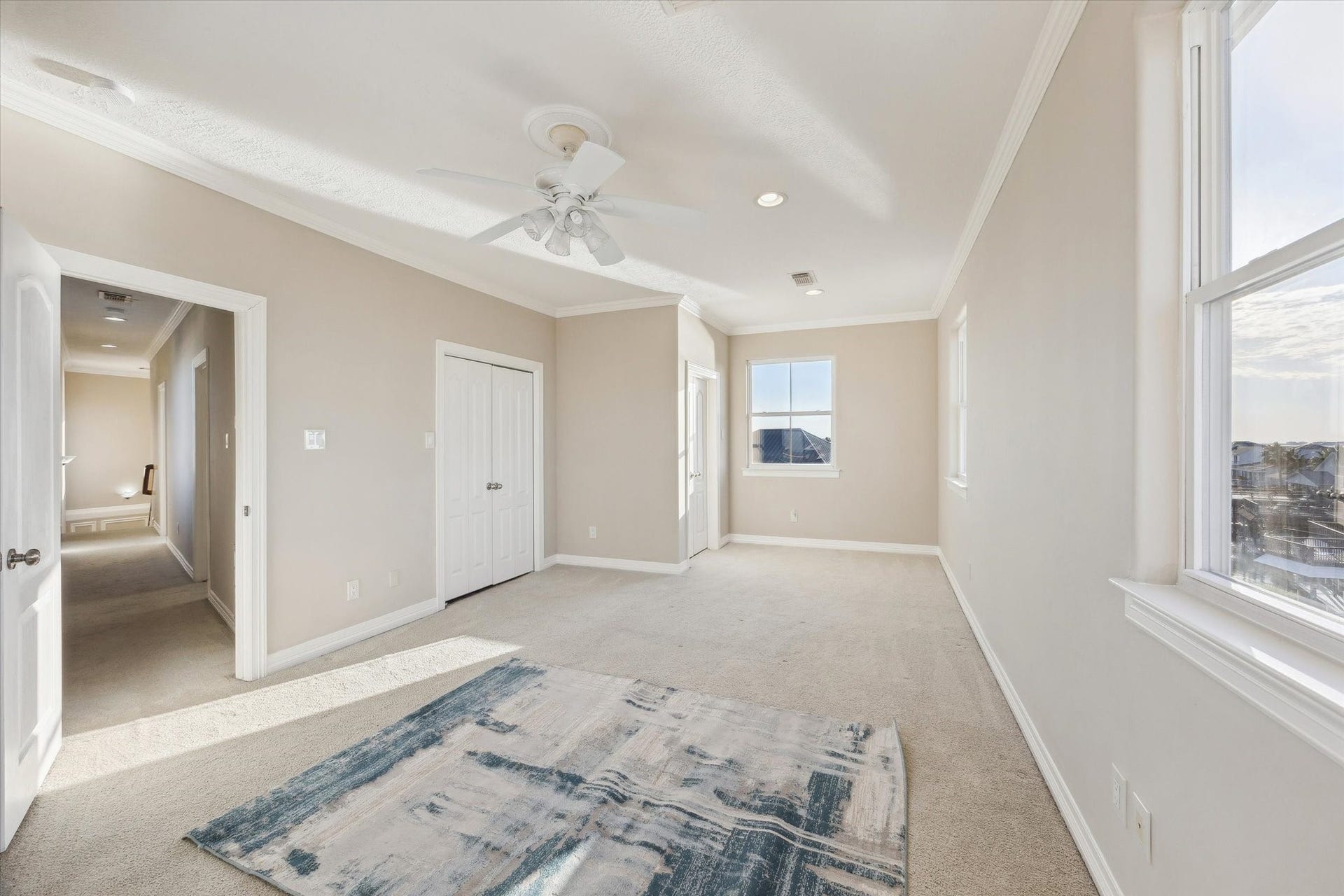 Large bedroom with windows on three sides overlooking your neighbors