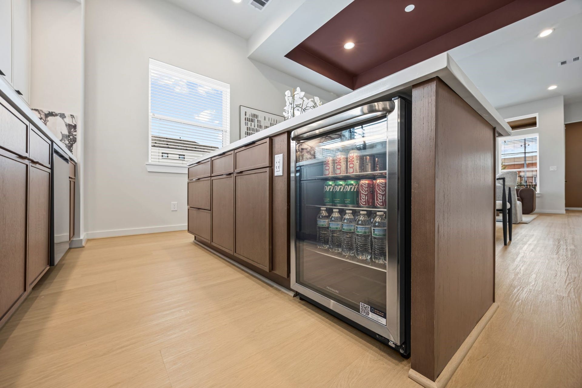 Modern kitchen with sleek cabinetry and a convenient built-in beverage fridge, perfect for entertaining and everyday convenience. **Model Home of similar layout & finishes.**