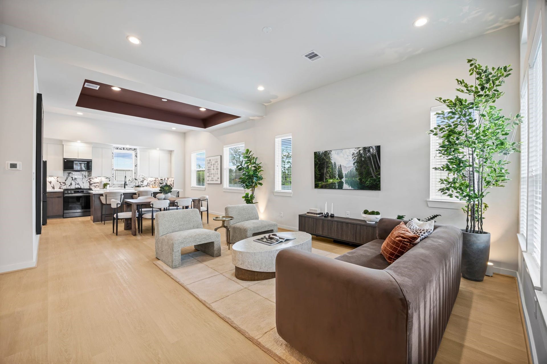 Experience seamless modern living in this open-concept space that effortlessly blends the chic kitchen, inviting dining area, and stylish living room, perfect for both relaxation and entertaining. **Model Home of similar layout & finishes.**
