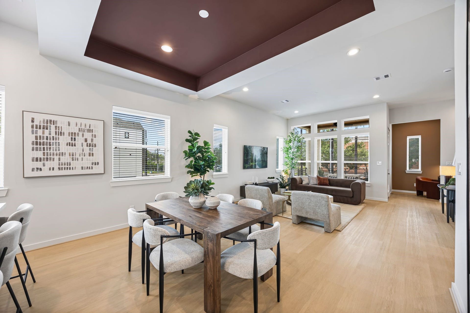 Experience effortless elegance in this open-concept living and dining area, where natural light floods through expansive windows, creating the perfect ambiance for gatherings and relaxation. **Model Home of similar layout & finishes.**