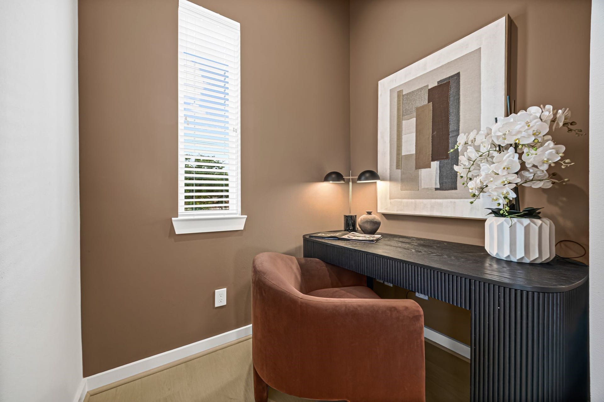 Discover a cozy and sophisticated study featuring a sleek desk, stylish decor, and ample natural light, perfect for focused work or creative inspiration. **Model Home of similar layout & finishes.**