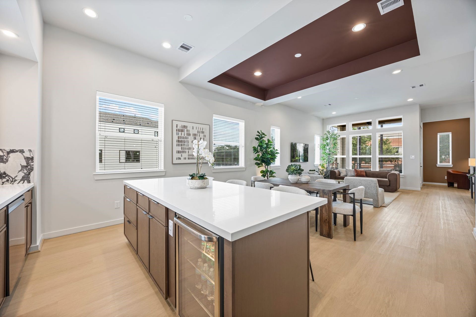 Experience seamless living with this open-concept kitchen, dining, and living area, featuring sleek finishes and abundant natural light for a perfect blend of style and functionality. **Model Home of similar layout & finishes.**