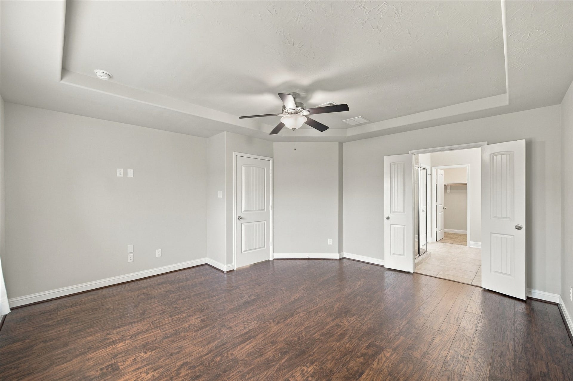 8119 W Pine Creek Bend, Cypress, TX 77433 This view offers a glimpse into the primary ensuite, providing a peek at the private retreat adjoining the primary bedroom.