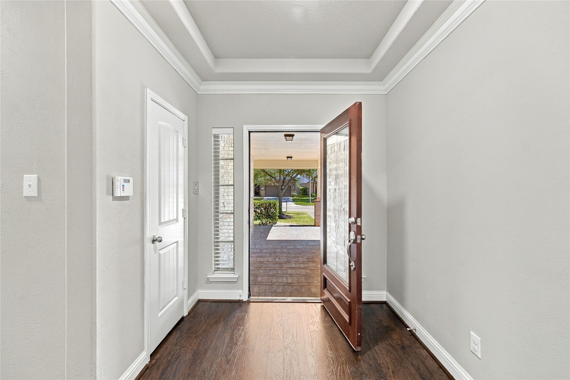 8119 W Pine Creek Bend, Cypress, TX 77433 A beautiful wood front door with elegant glass detailing creates a warm and inviting welcome as you enter the home.