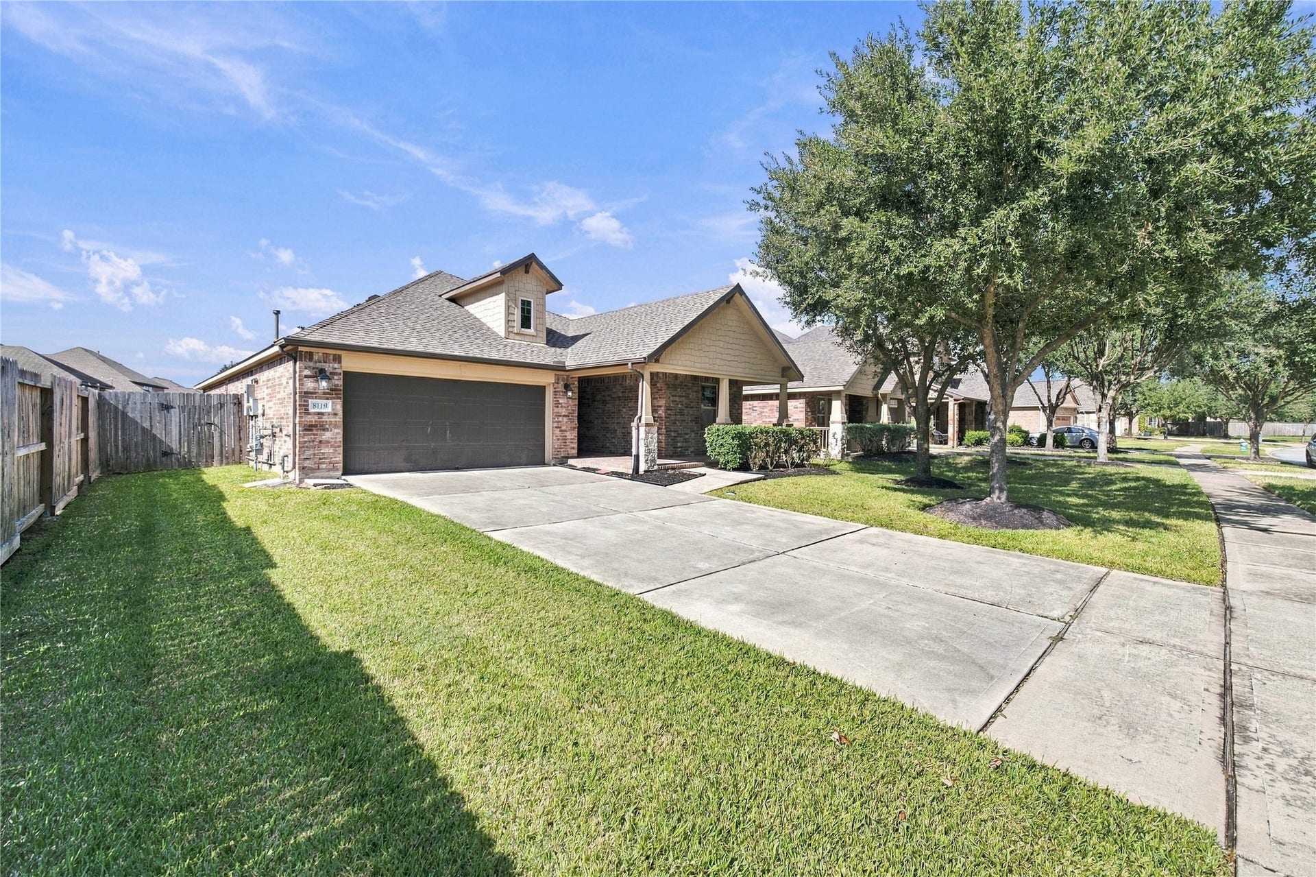 8119 W Pine Creek Bend, Cypress, TX 77433 The home offers an attached two-car garage.