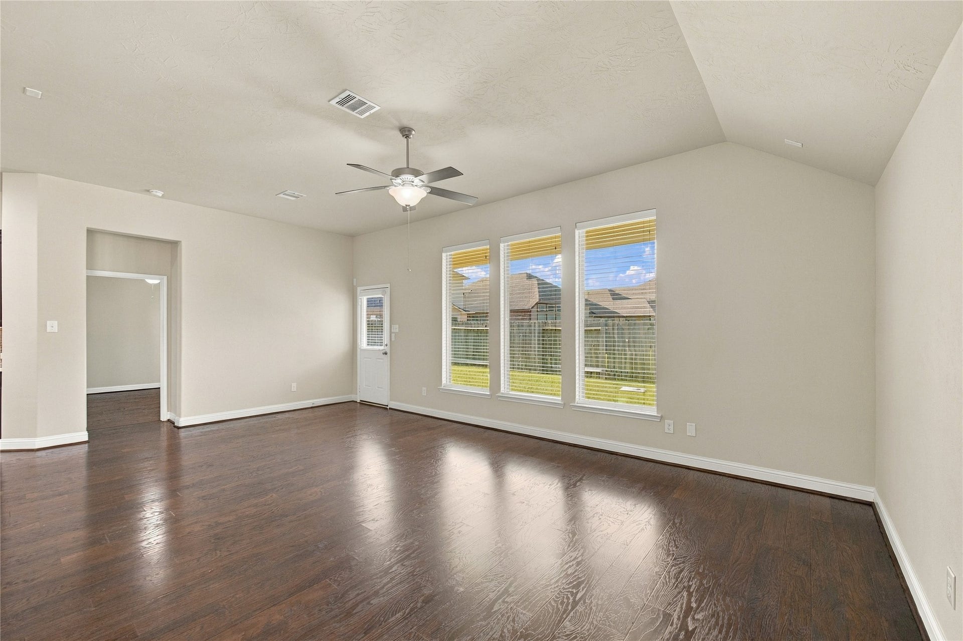 8119 W Pine Creek Bend, Cypress, TX 77433 The open layout of the family room creates a seamless flow into the kitchen, while natural light streams through the windows.