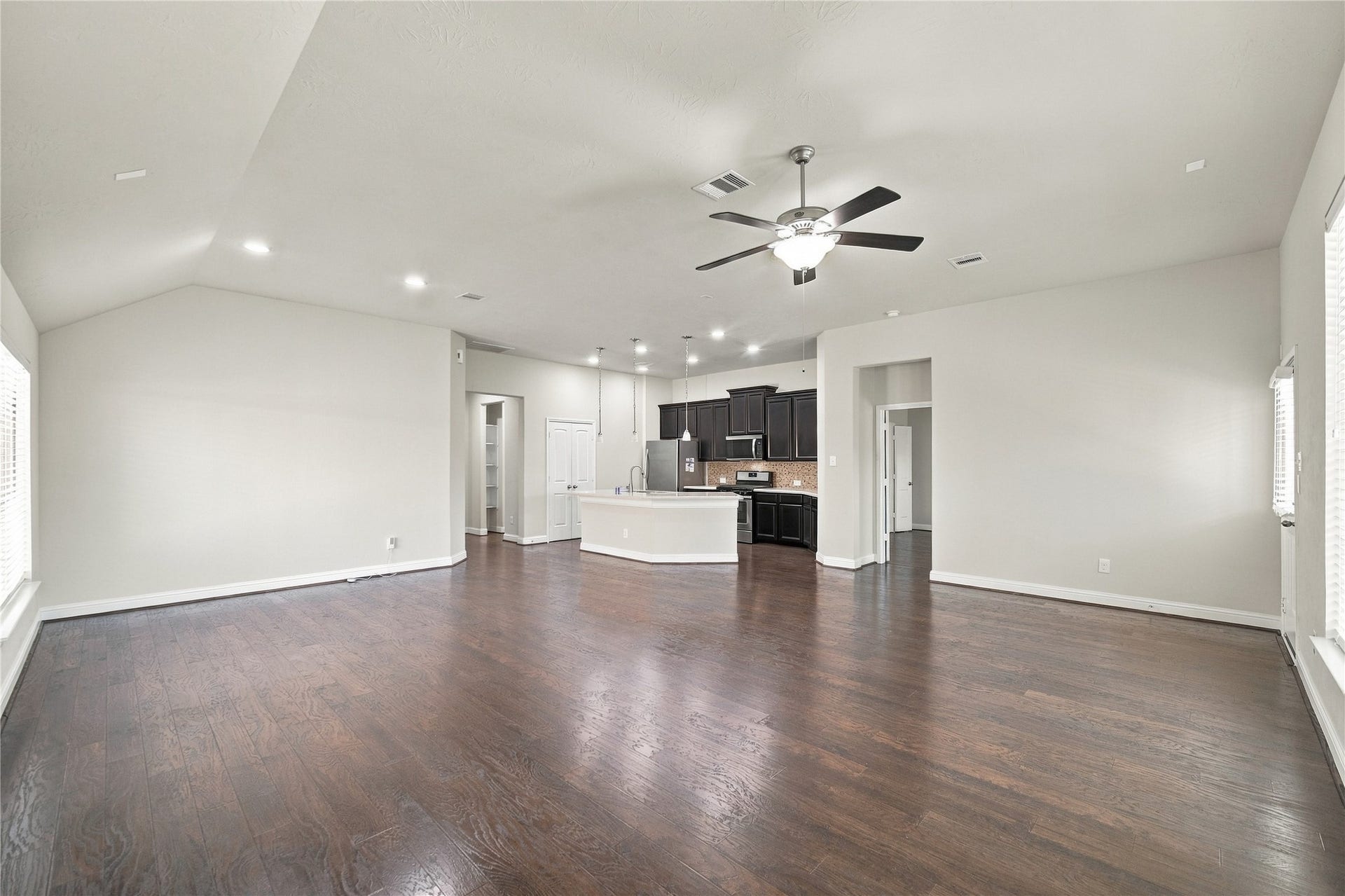8119 W Pine Creek Bend, Cypress, TX 77433 The open layout creates a seamless flow between the family room and kitchen, making the space ideal for everyday living and entertaining.