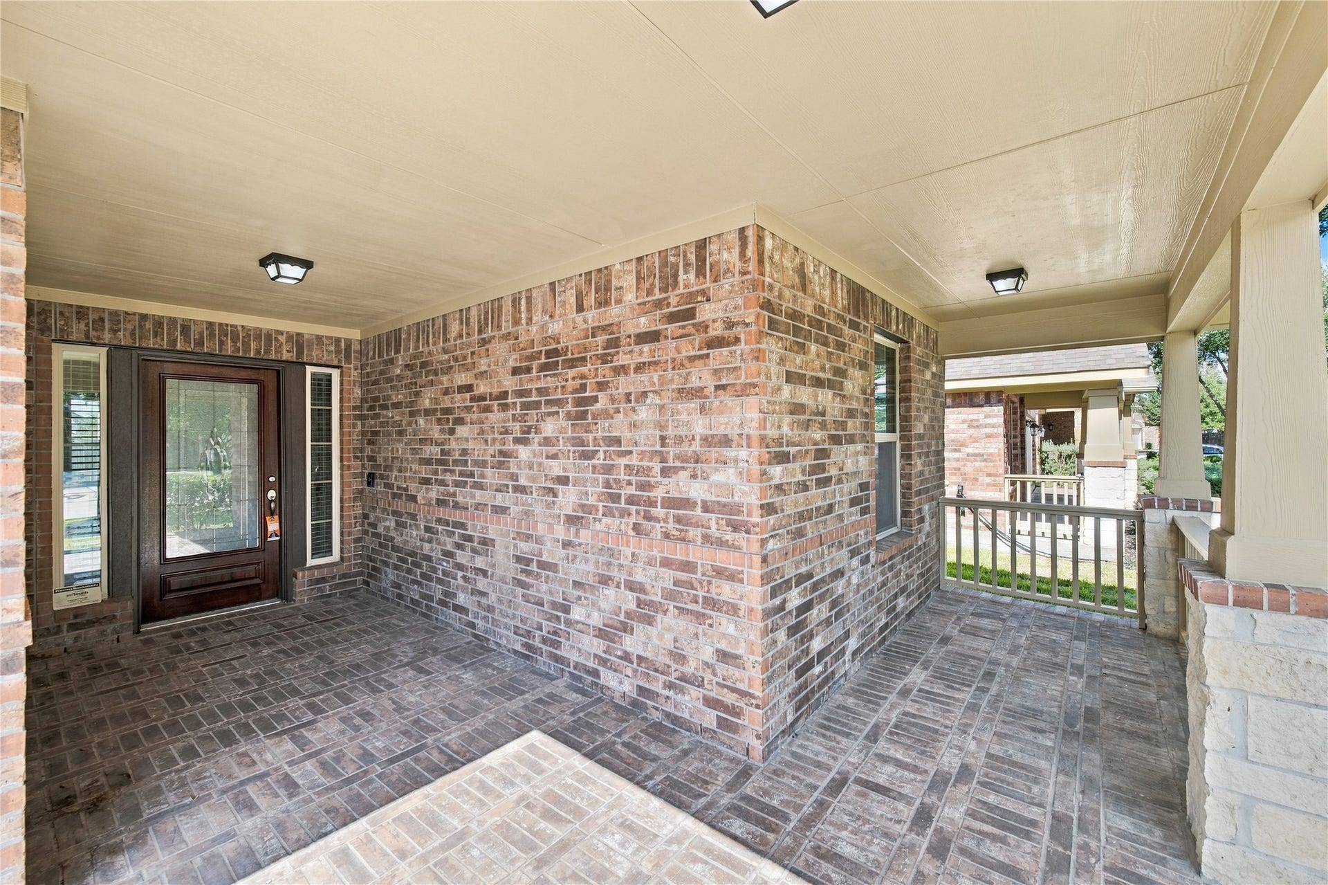 8119 W Pine Creek Bend, Cypress, TX 77433 An inviting covered brick front porch adds charm and curb appeal.