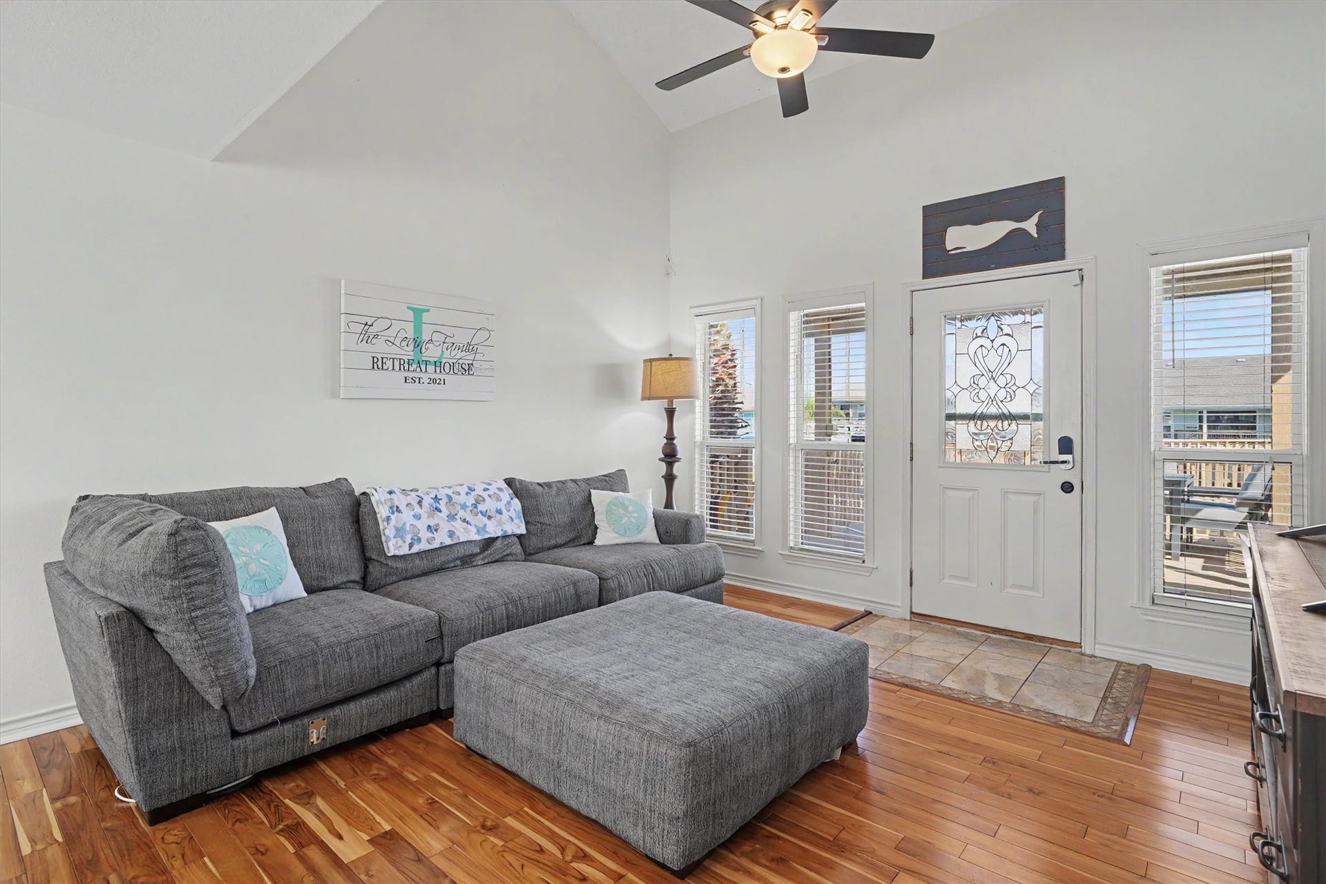 The living room is large with vaulted ceilings, gorgeous floors and plenty of windows to view the water
