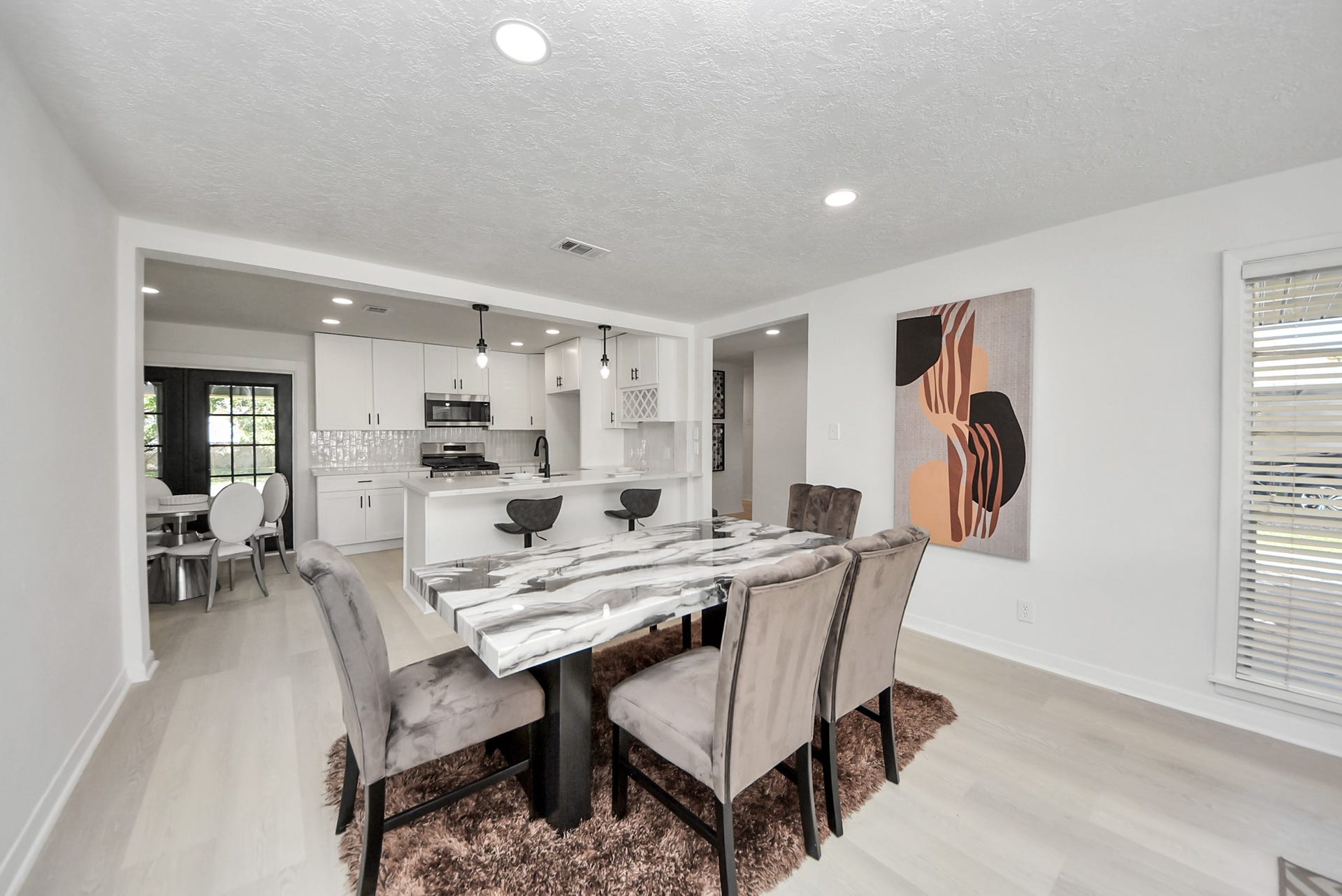 9610 Westview Drive, Houston, TX 77055 Enjoy the inviting open-concept layout, where the dining area seamlessly connects to the kitchen, creating a spacious and well-connected setting for everyday living and entertaining.