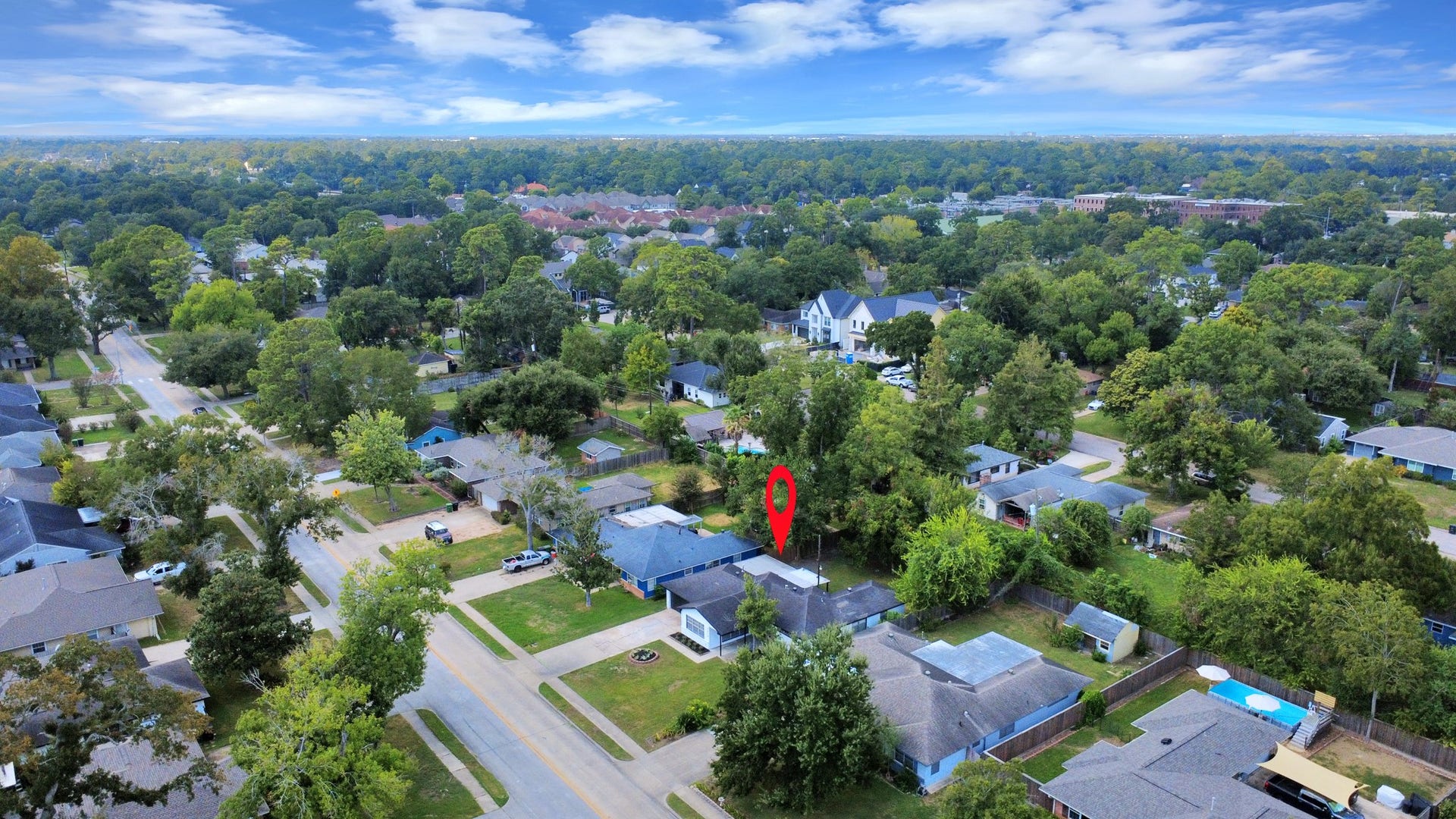 9610 Westview Drive, Houston, TX 77055 A broad aerial view showcasing the property's location within an established residential neighborhood, surrounded by mature trees, well-spaced homes, and convenient street access.