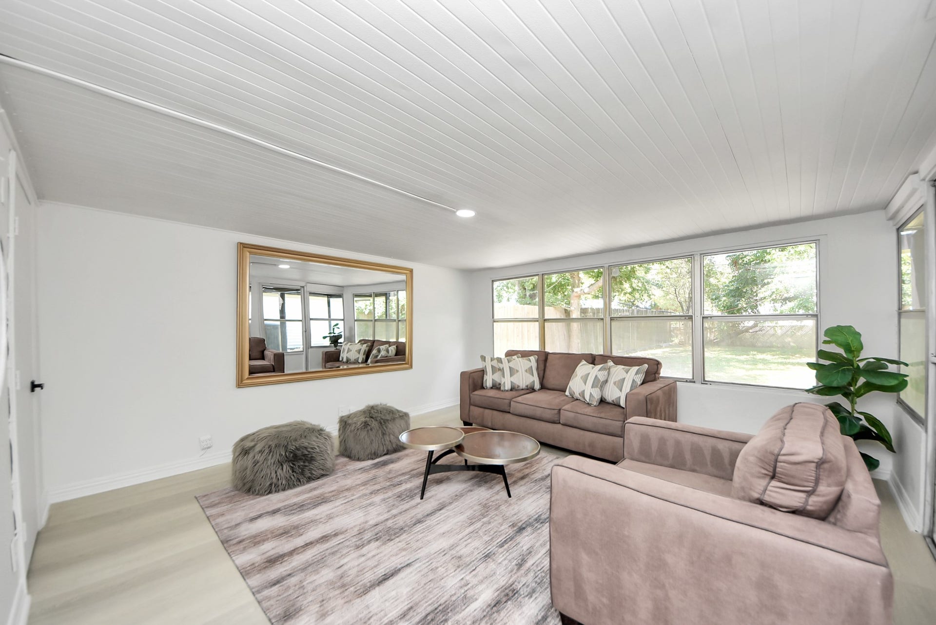 9610 Westview Drive, Houston, TX 77055 A bright, spacious living area featuring large windows, an open layout, light-colored flooring, and plenty of natural light. The generous room offers flexibility for comfortable everyday living and entertaining.