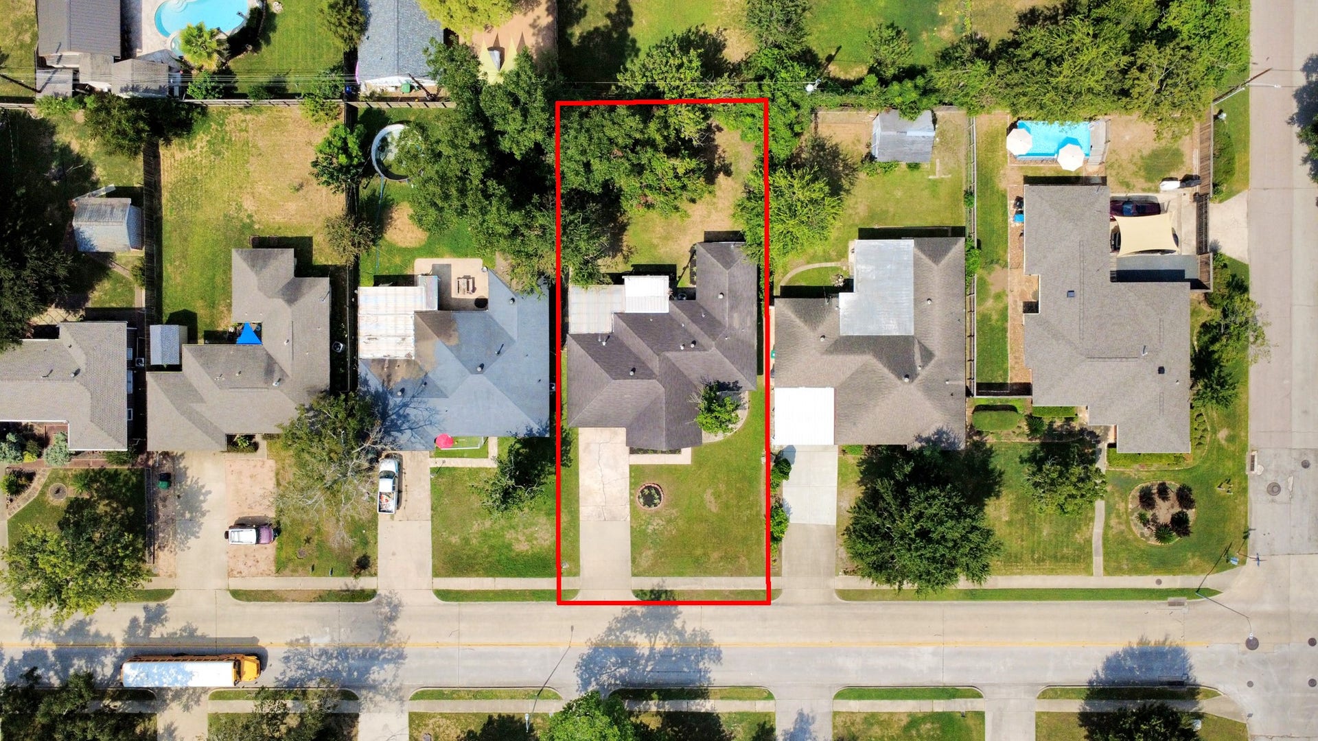 9610 Westview Drive, Houston, TX 77055 An aerial view showcasing the home's spacious lot, front yard, driveway, and surrounding residential setting. The property offers a well-defined outdoor area with mature greenery and established landscaping.