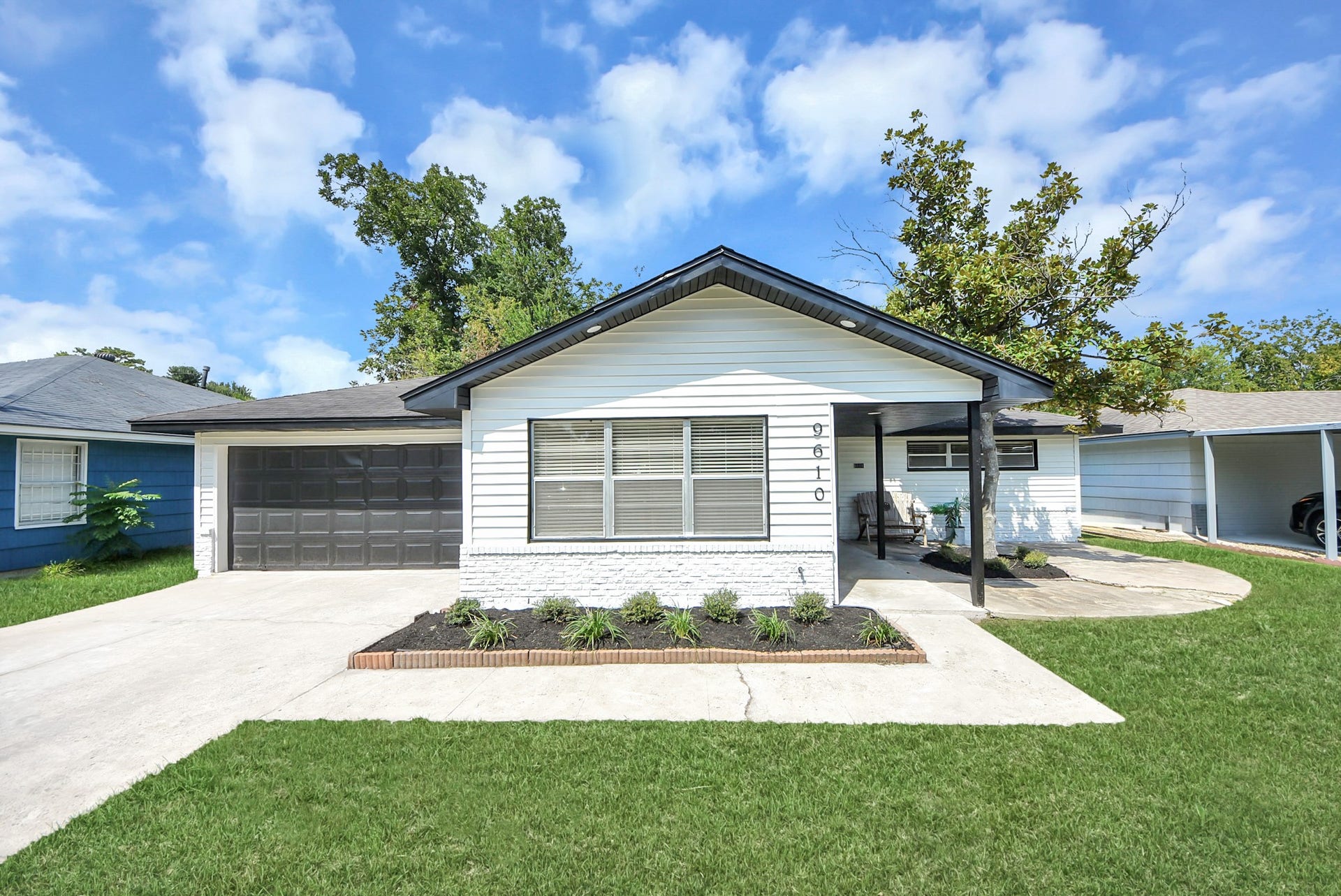 9610 Westview Drive, Houston, TX 77055 A charming mid-century home featuring classic architectural character, a welcoming covered entry, manicured landscaping, and an attached two-car garage.