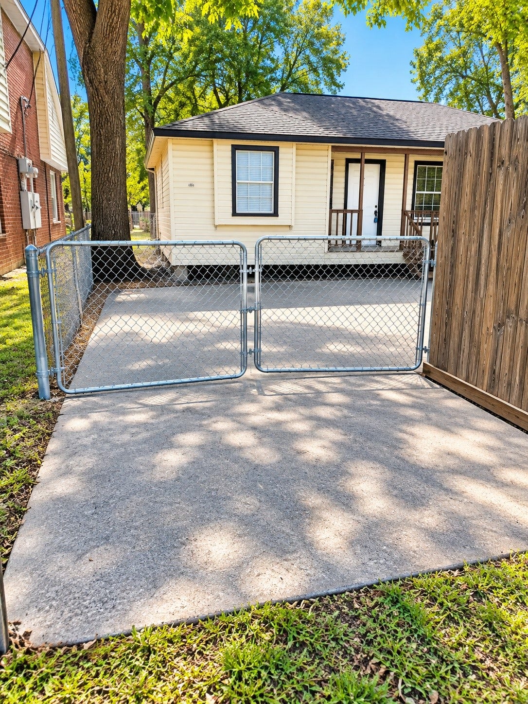 4712 Oleander Street, Bacliff, TX 77518 gated driveway - concrete starts closer to the fence--AI used to brighten and clean up look