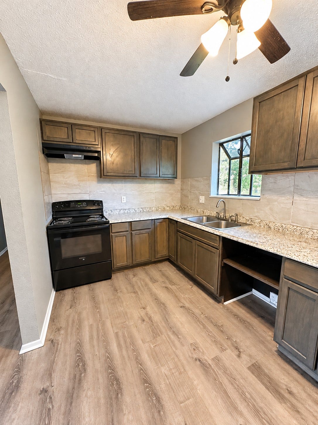 4712 Oleander Street, Bacliff, TX 77518 Kitchen with garden window box and open shelving for baskets