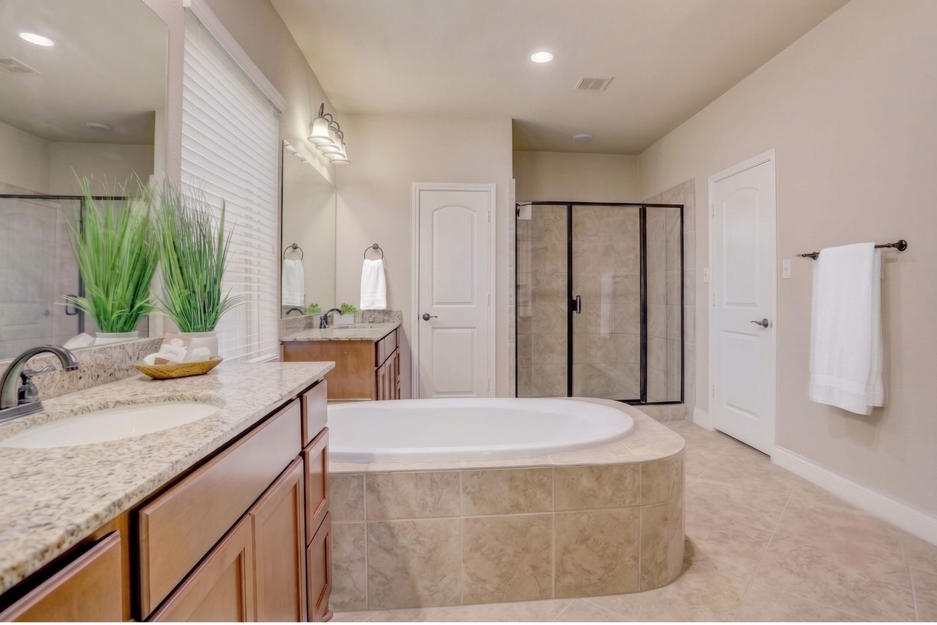 13308 Paxton Hill Court, Pearland, TX 77584 Unwind in the spacious primary bath featuring dual vanities, a relaxing soaking tub, separate walk-in shower, and generous storage designed for everyday comfort.