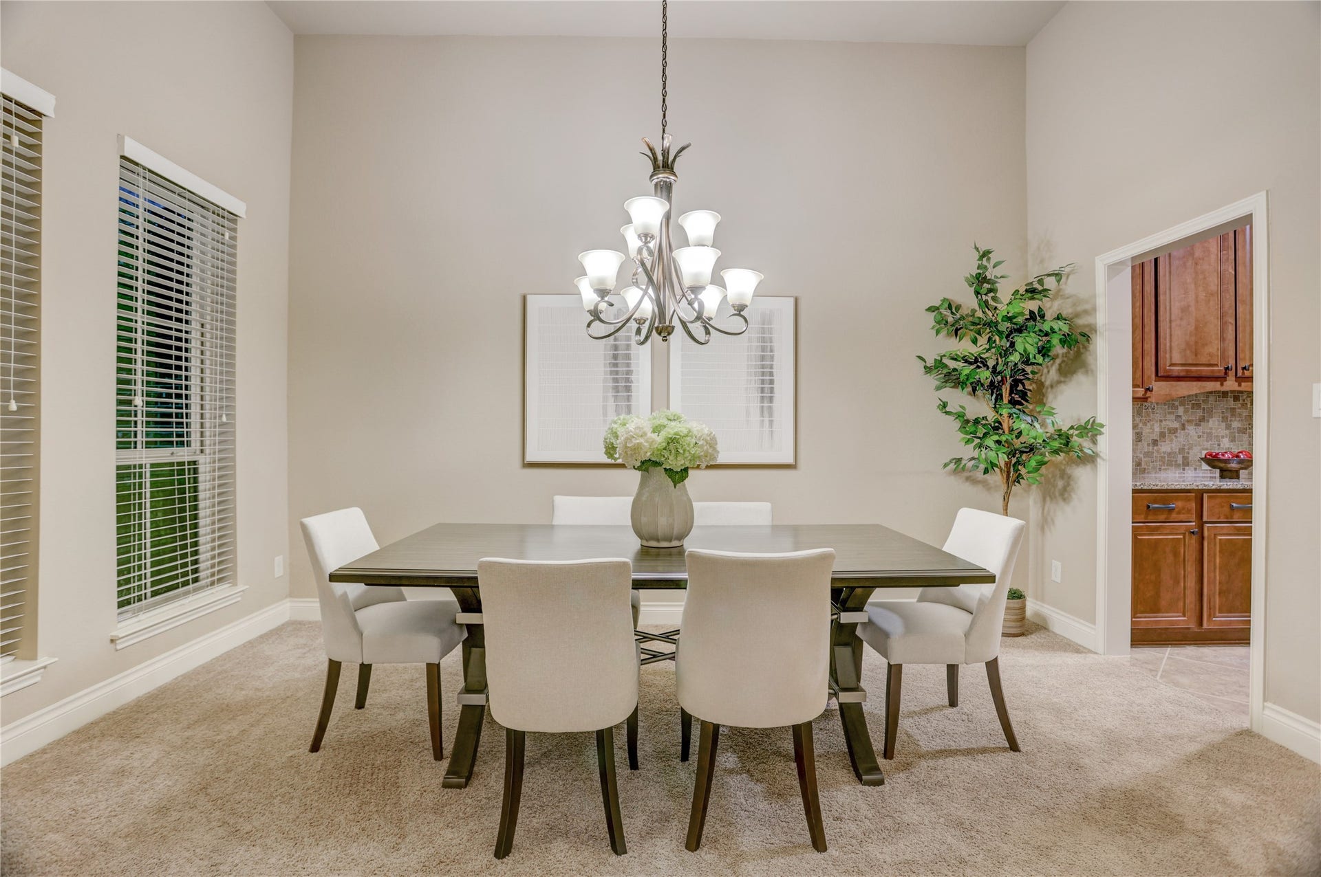 13308 Paxton Hill Court, Pearland, TX 77584 Elegant formal dining room featuring soaring ceilings, abundant natural light, and a stylish chandelier that creates the perfect setting for holiday gatherings, dinner parties, and everyday entertaining. Conveniently located adjacent to the kitchen for seamless hosting.