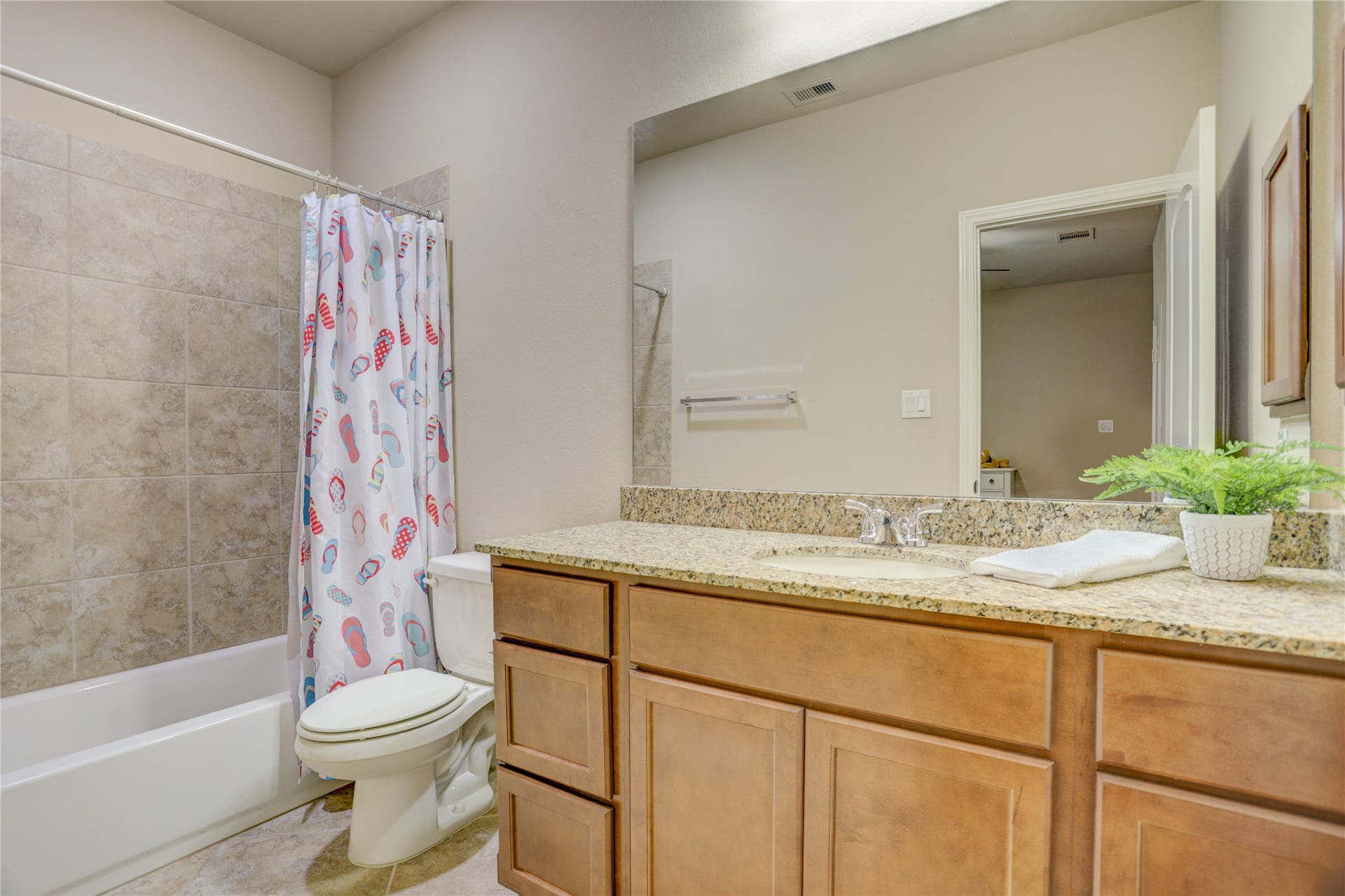 13308 Paxton Hill Court, Pearland, TX 77584 The private downstairs guest suite includes its own en suite bathroom with a granite vanity and a tub/shower combination, offering comfort and convenience for overnight guests or multi-generational living.