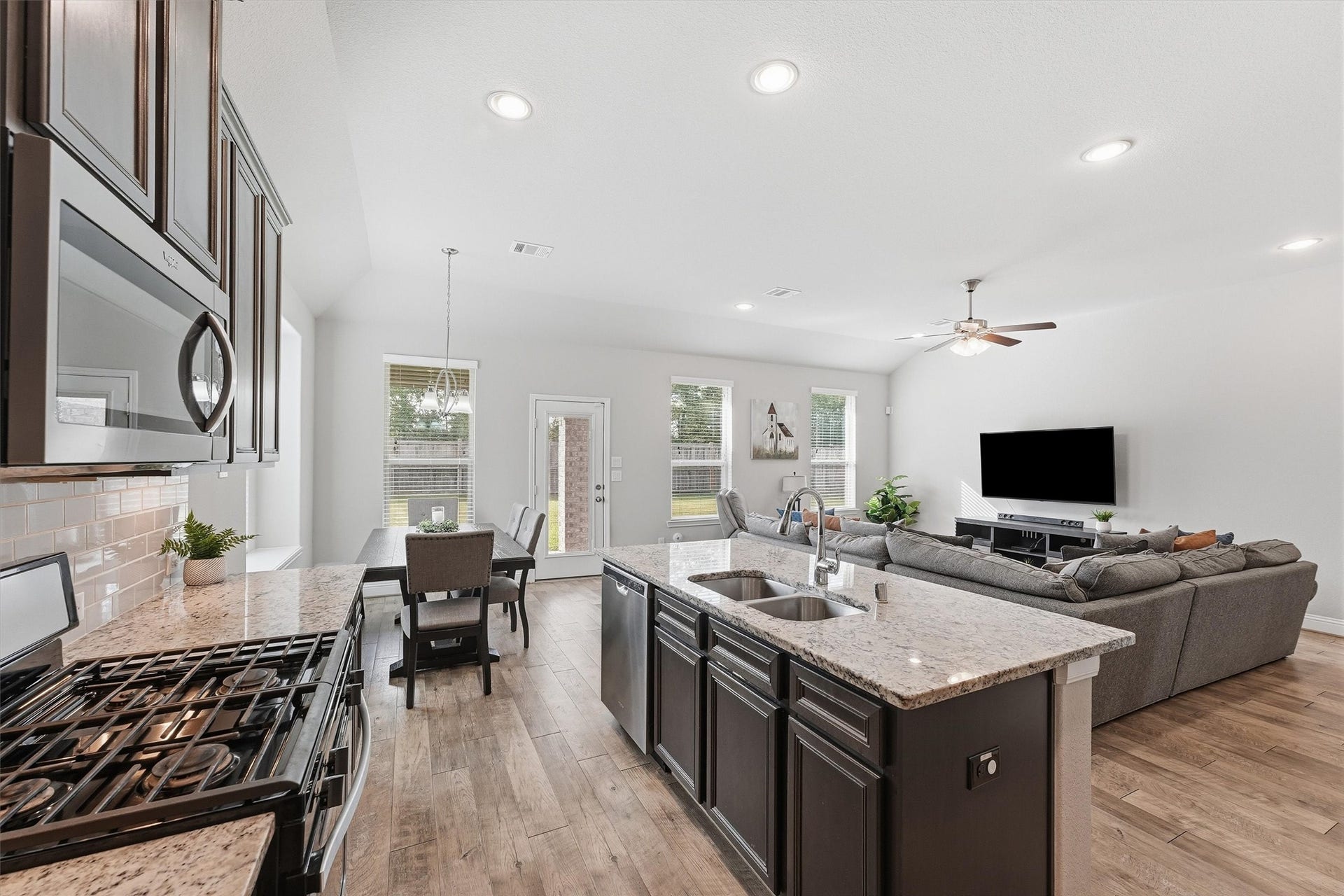 31549 Timber Grove Lane, Spring, TX 77386 True open-concept living connects the kitchen, dining and family roomideal for entertaining.