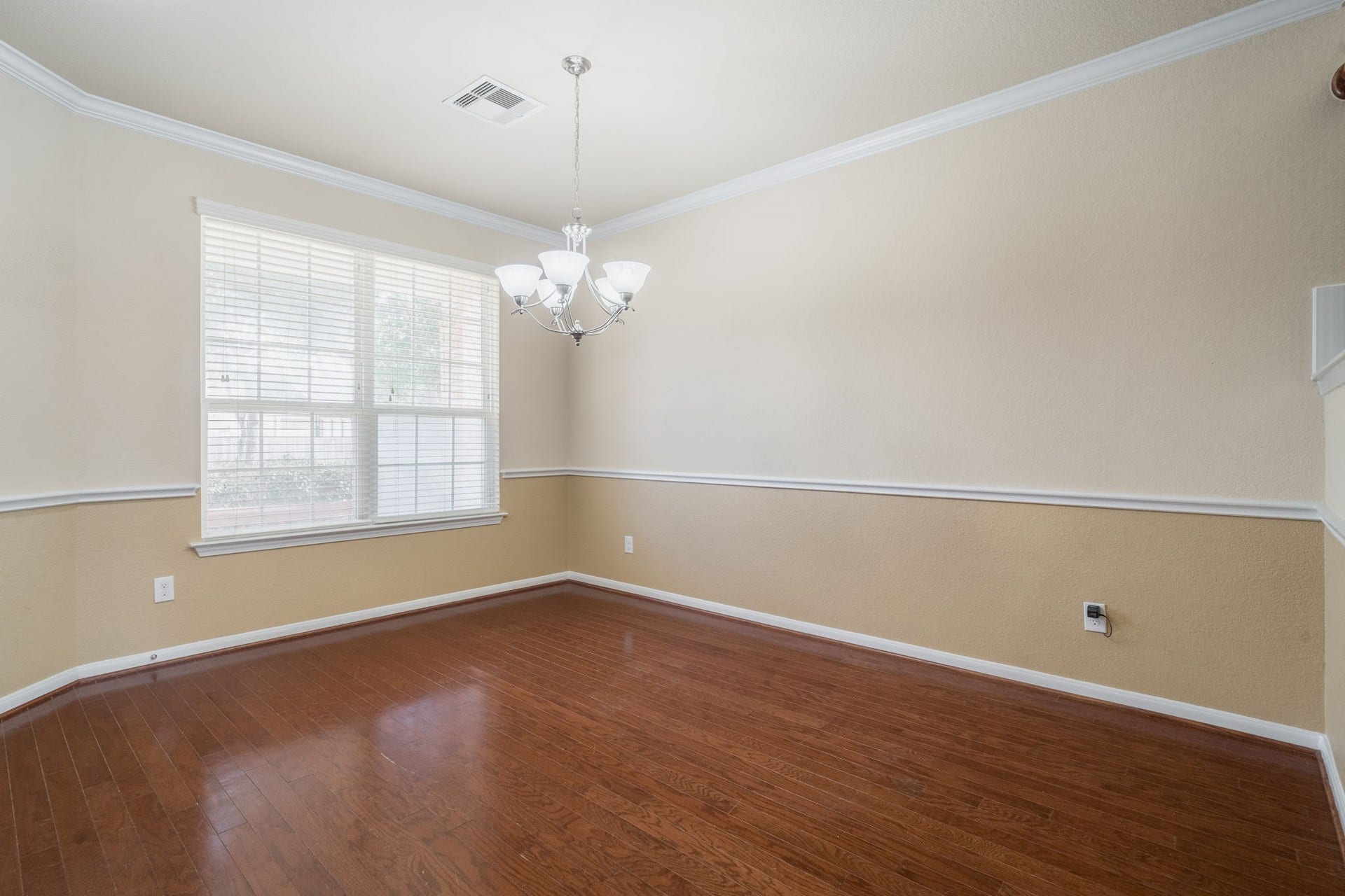 7222 Stevenson Drive, Missouri City, TX 77459 Formal dining room featuring rich wood flooring, elegant chair rail molding, crown molding & an abundance of natural light.