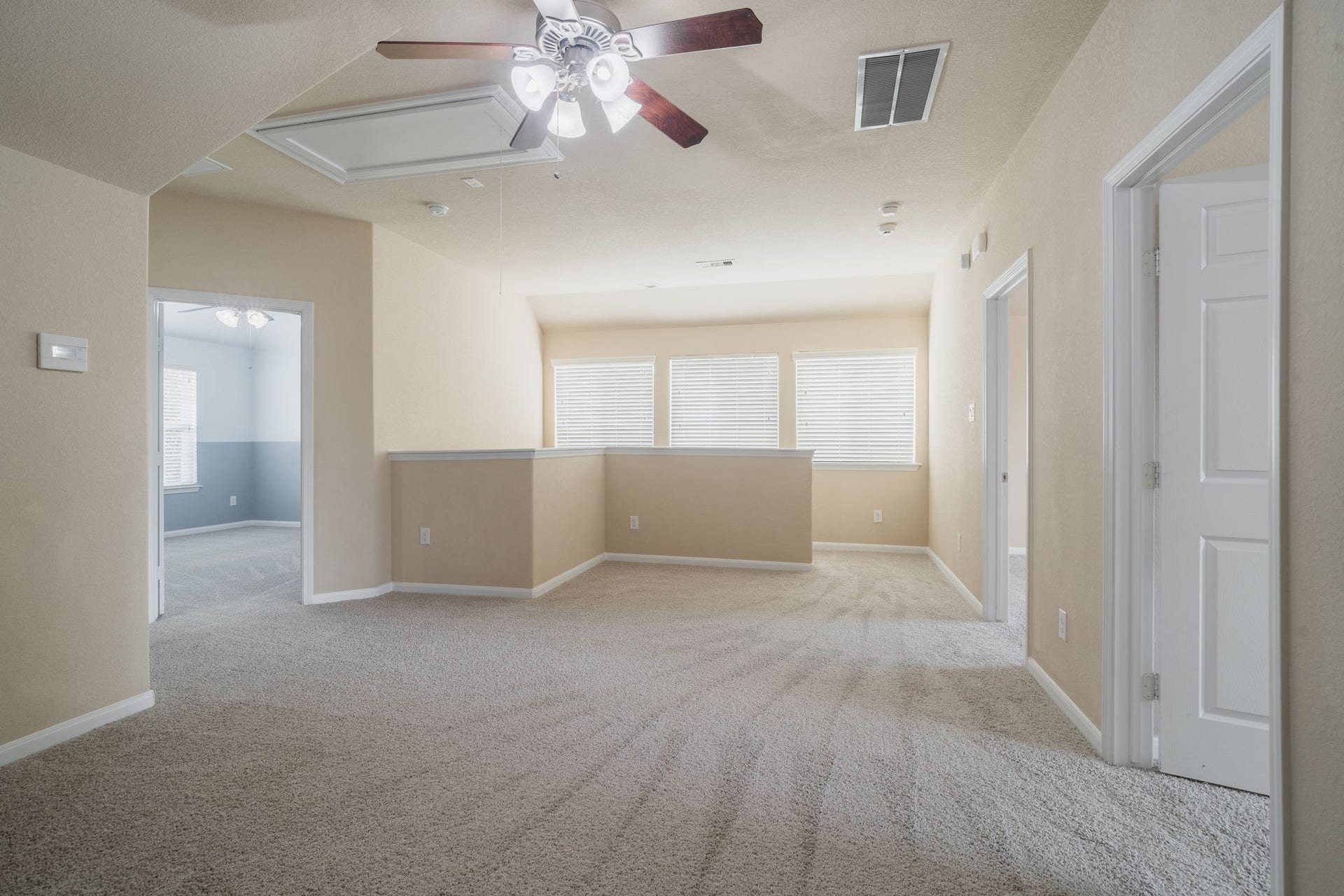 7222 Stevenson Drive, Missouri City, TX 77459 Another view of the upstairs game room showcasing its generous layout, abundant natural light & convenient access to the secondary bedrooms.