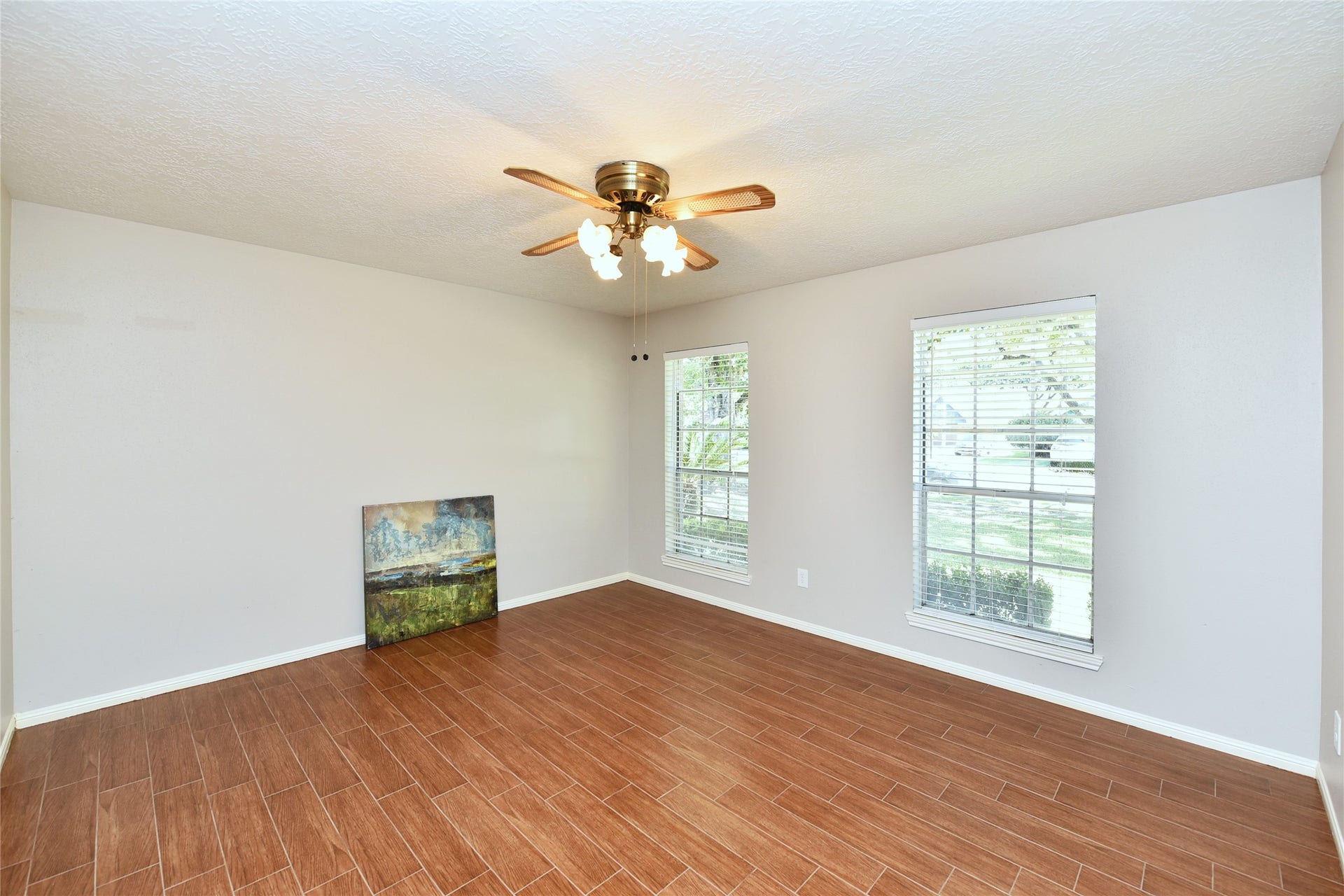 907 Sugarfield Court, Sugar Land, TX 77498 The formal living with wood tile would make a great study.