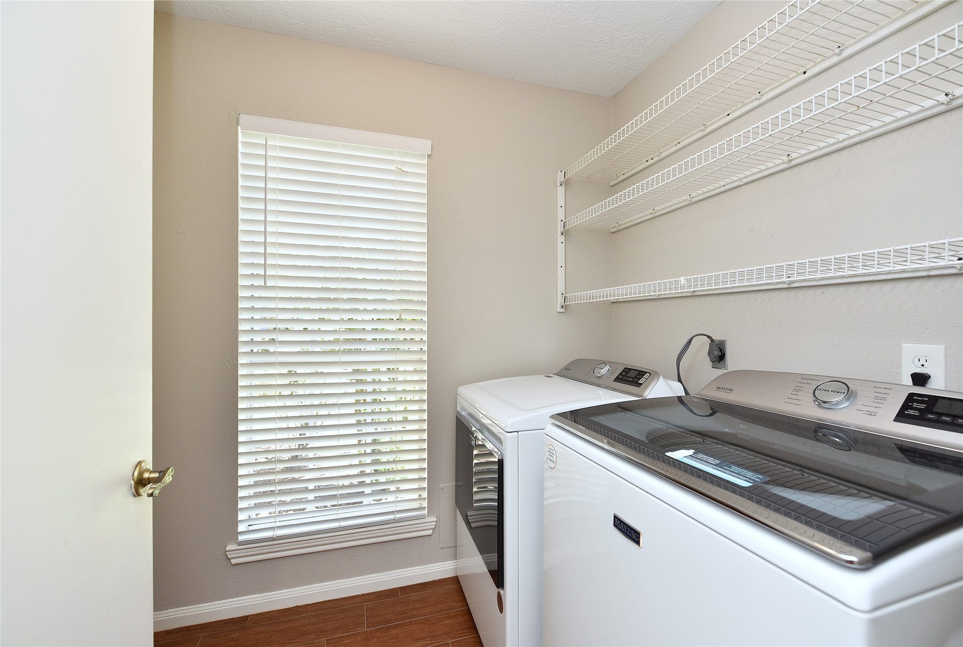 907 Sugarfield Court, Sugar Land, TX 77498 The full-sized utility room has extra space for storage behind the door