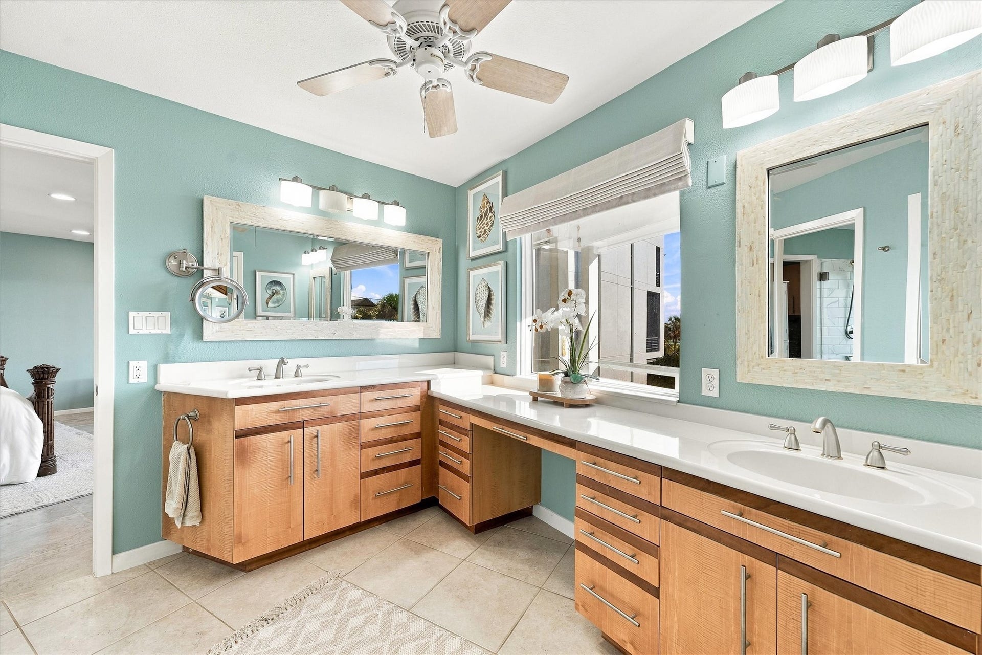 4207 Barataria Court, Galveston, TX 77554 Sunlight spills across the spacious vanity as another island morning begins. Two sinks, a seated dressing area, and plentiful storage.