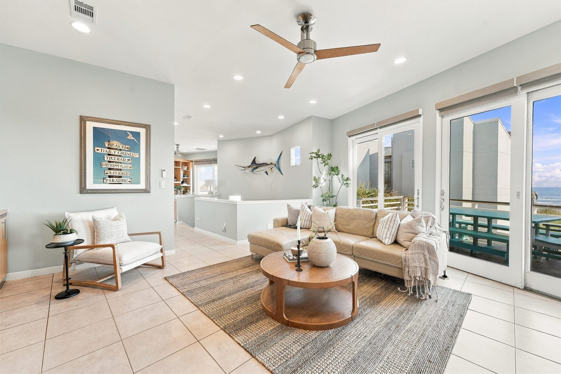4207 Barataria Court, Galveston, TX 77554 Gather for conversation, curl up after a beach day, or step onto the balcony to enjoy the coastal breeze. Sunlight and water views fill this inviting living space, keeping the shoreline part of every gathering.