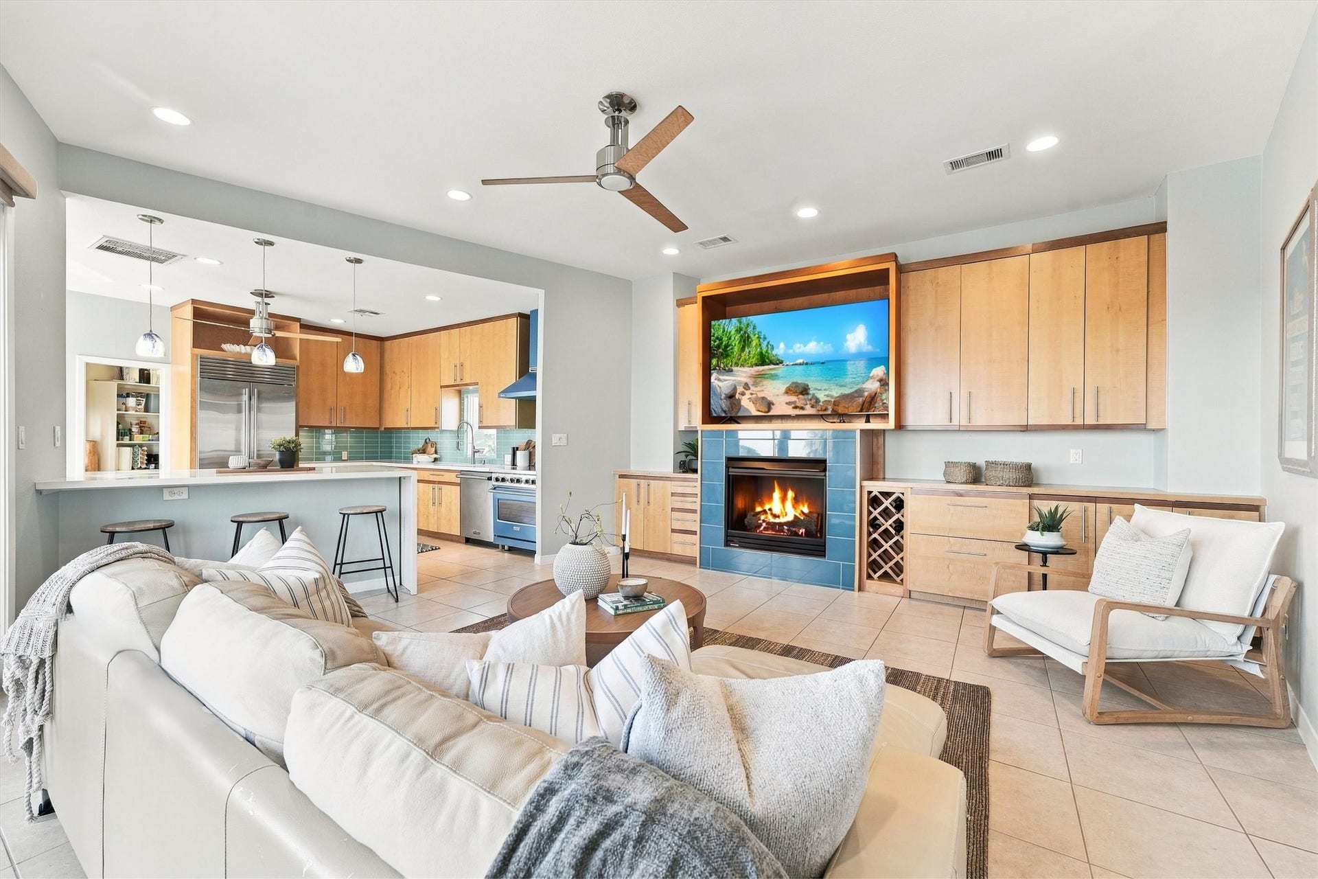 4207 Barataria Court, Galveston, TX 77554 Keep the conversation flowing from the breakfast bar to the fireside seating area. The open layout brings everyone together, with warm wood built-ins, a wine rack, and coastal blue accents adding character.