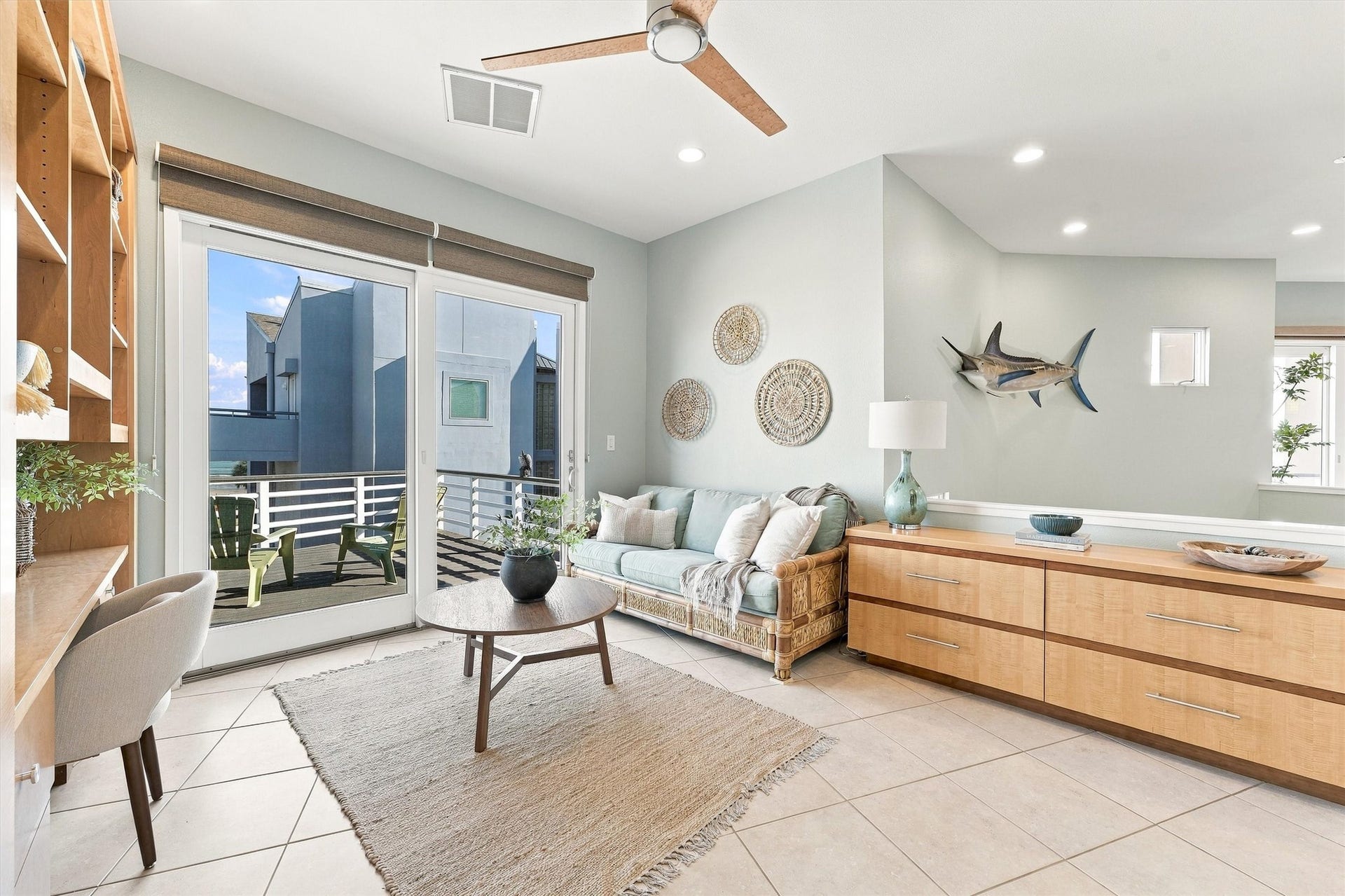 4207 Barataria Court, Galveston, TX 77554 Natural textures and soft coastal colors create a welcoming spot for quiet conversation. Built-in drawers and shelving offer generous storage, and the adjoining balcony extends your living space into the island air.