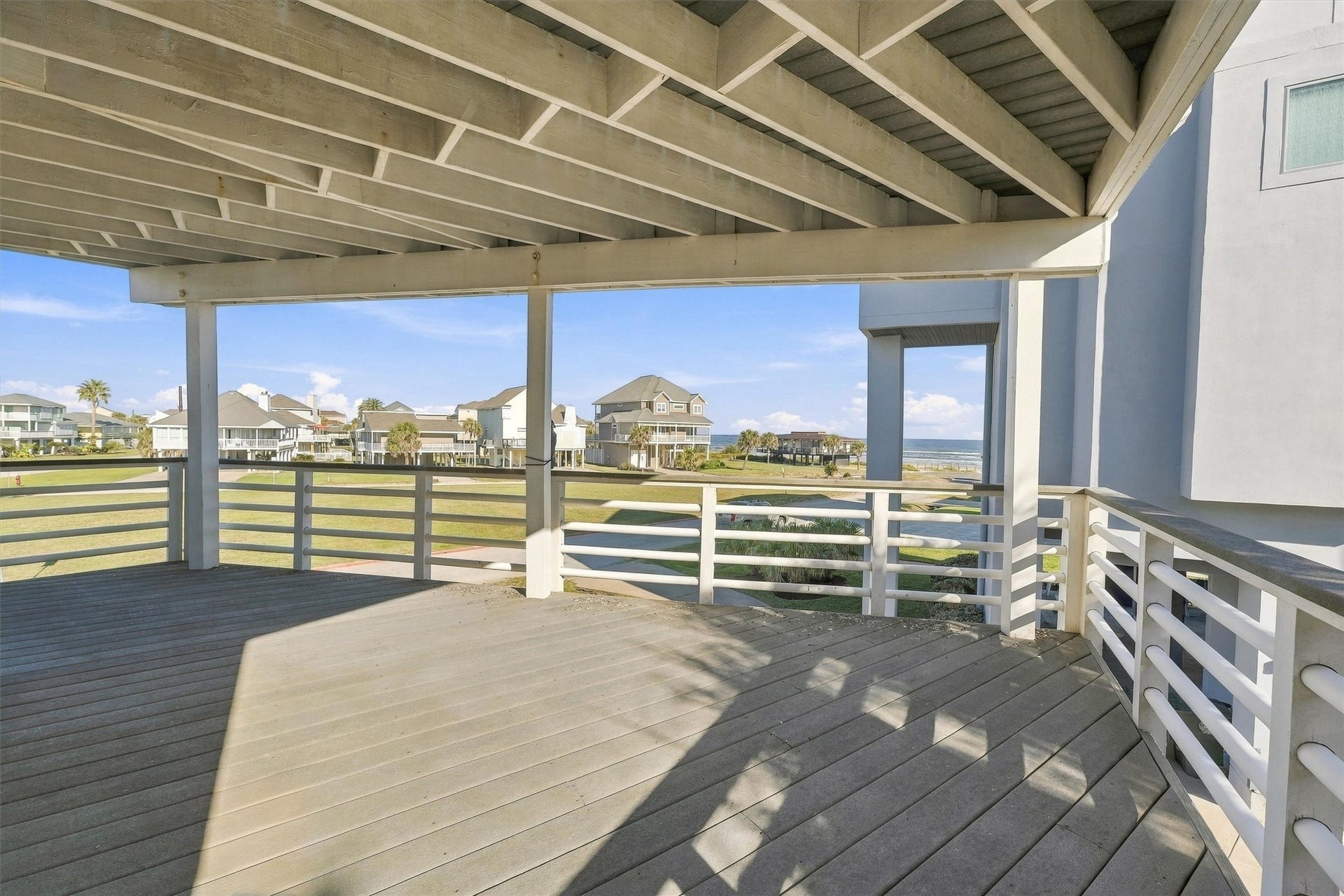 4207 Barataria Court, Galveston, TX 77554 Enjoy your morning coffee in the shade as waves roll toward shore. This spacious covered balcony offers room for outdoor seating and relaxed gatherings, with beach views.