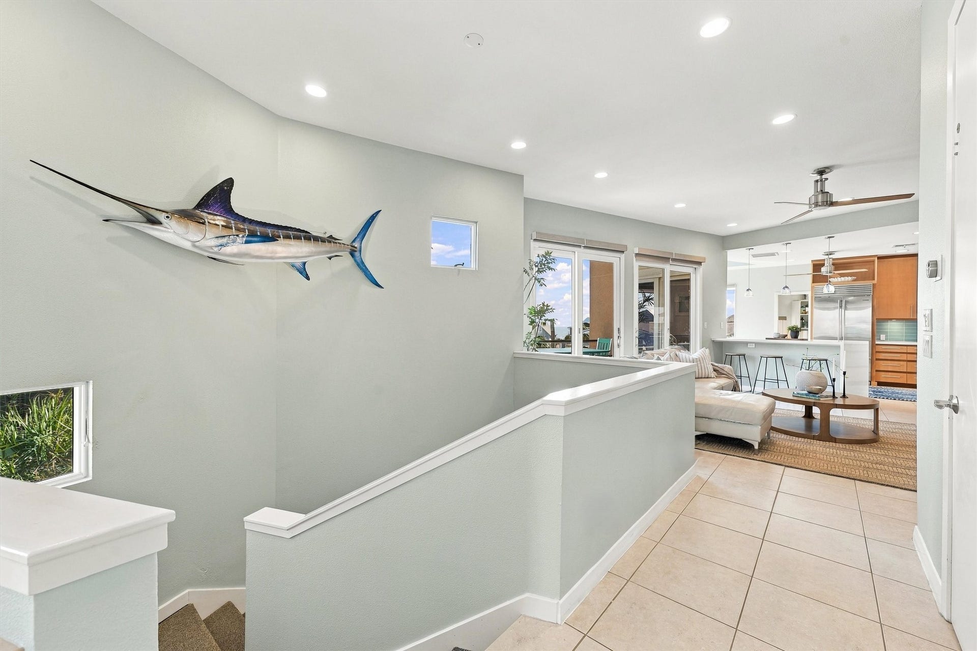4207 Barataria Court, Galveston, TX 77554 Head upstairs to the heart of the home, where the living area and kitchen come together in a bright, open layout. Coastal accents and two balconies set the scene for relaxed gatherings.