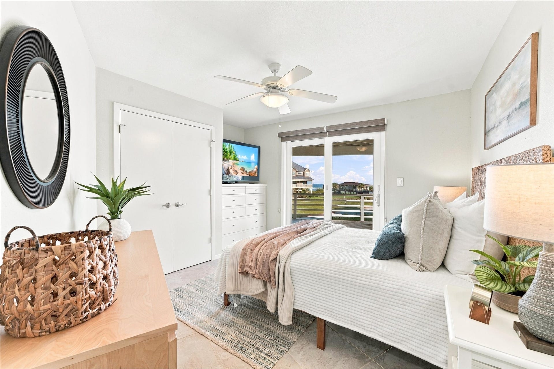 4207 Barataria Court, Galveston, TX 77554 Wake to coastal scenery and sunlight streaming through sliding glass doors. With direct access to the covered balcony, this inviting bedroom puts morning coffee and a refreshing sea breeze just steps from your bed.