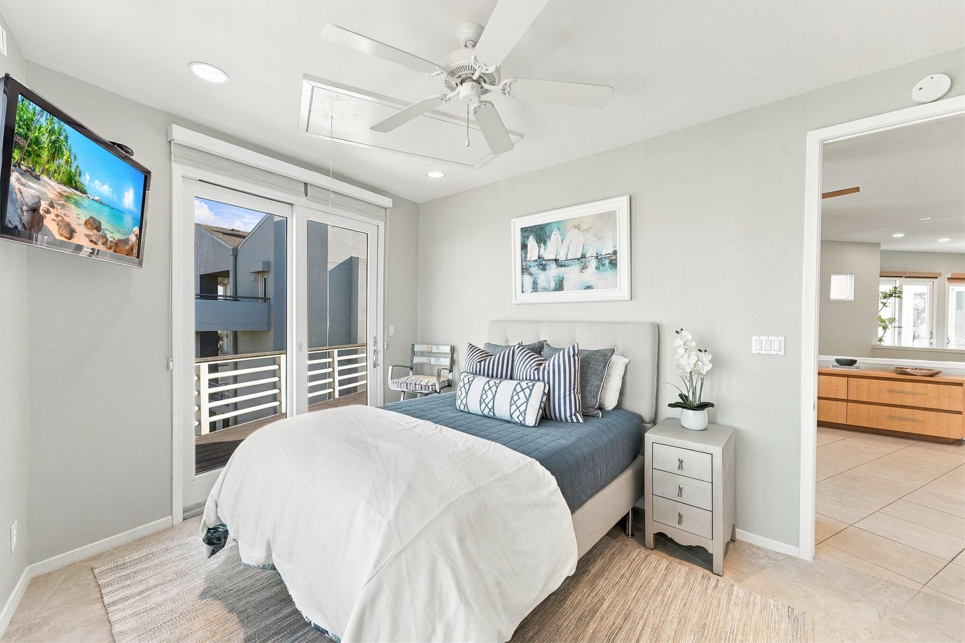 4207 Barataria Court, Galveston, TX 77554 After a day of sunshine, settle into this restful coastal bedroom. Soft blues, crisp whites, and direct balcony access create an inviting retreat for slow mornings and relaxing evenings.