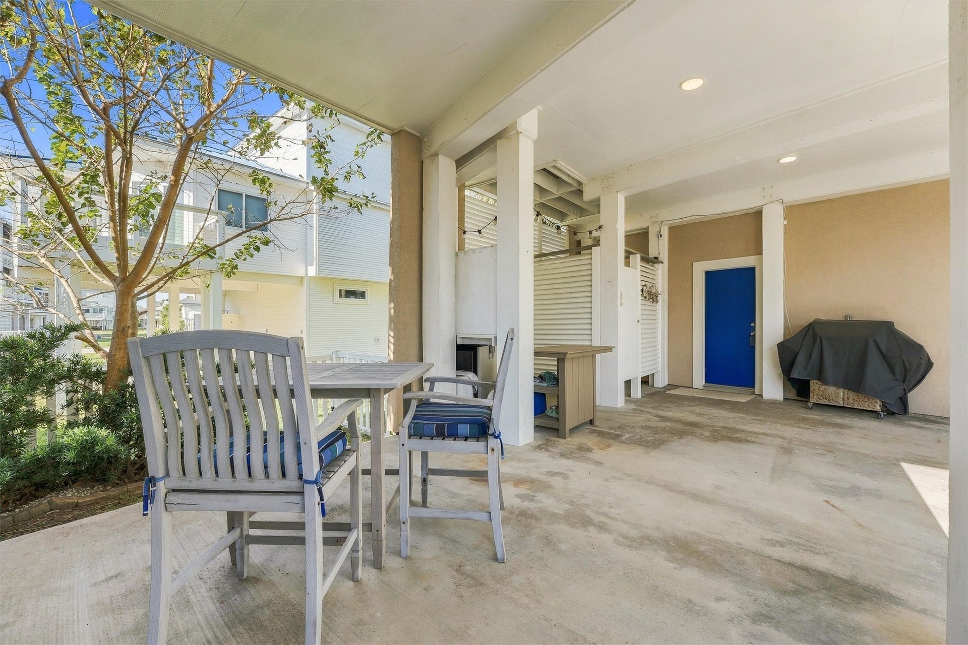4207 Barataria Court, Galveston, TX 77554 Gather downstairs for a casual cookout after a sun-filled beach day. A shaded dining area and nearby grill create an easygoing setting for sharing a meal and recounting the days adventures.