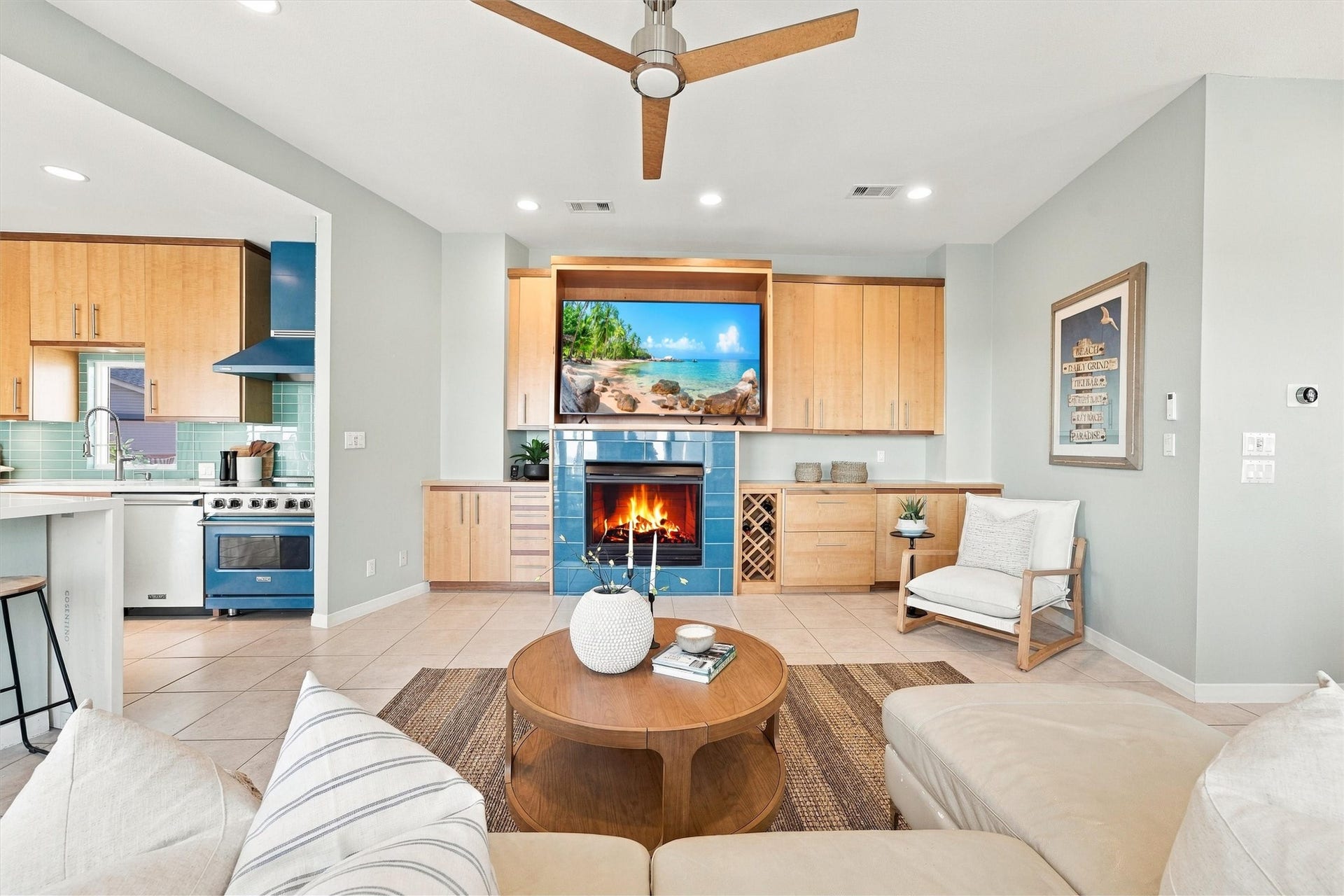 4207 Barataria Court, Galveston, TX 77554 Settle in beside the fireplace. Enjoy a glass of wine, or a beverage from the 2 refrigerator drawers built in, framing this welcoming gathering space, while the open kitchen keeps the conversation flowing.