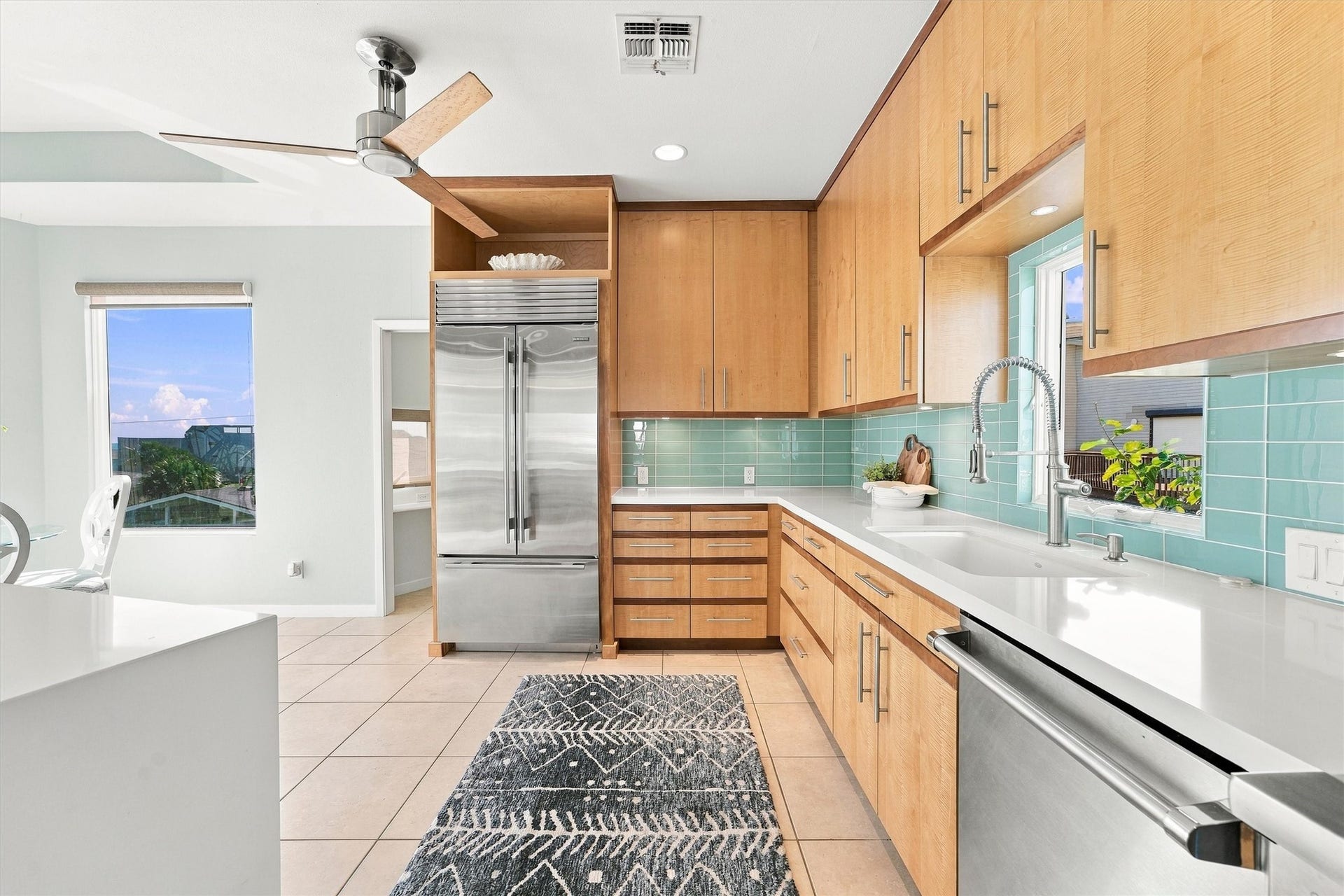 4207 Barataria Court, Galveston, TX 77554 Generous cabinetry, a built-in stainless refrigerator, and ample counter space make this kitchen ready for everything from quick beach snacks to luxury dinners.