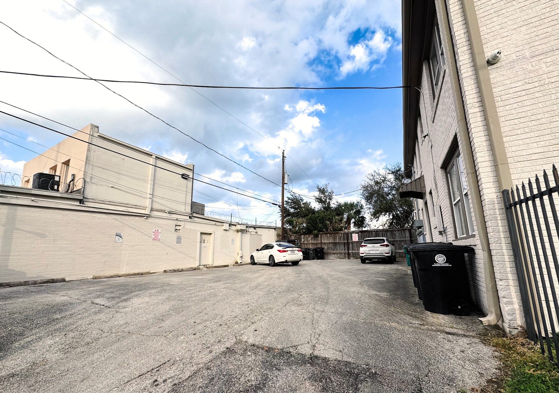 1660 Hawthorne Street, Houston, TX 77006 Rear parking and additional income. Rear parking area serving the eight-unit property, with multiple parking spaces and direct access to the building. The parking area is currently leased and provides an additional source of income beyond the residential units.