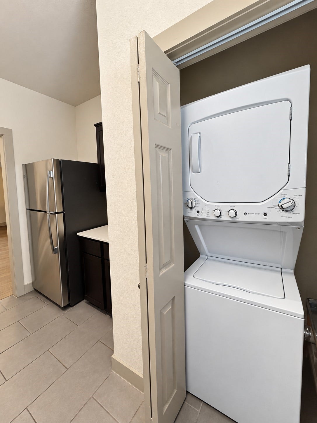 1660 Hawthorne Street, Houston, TX 77006 Representative unit laundry. Convenient in-unit stacked washer and dryer located adjacent to the kitchen in the pictured residential unit.
