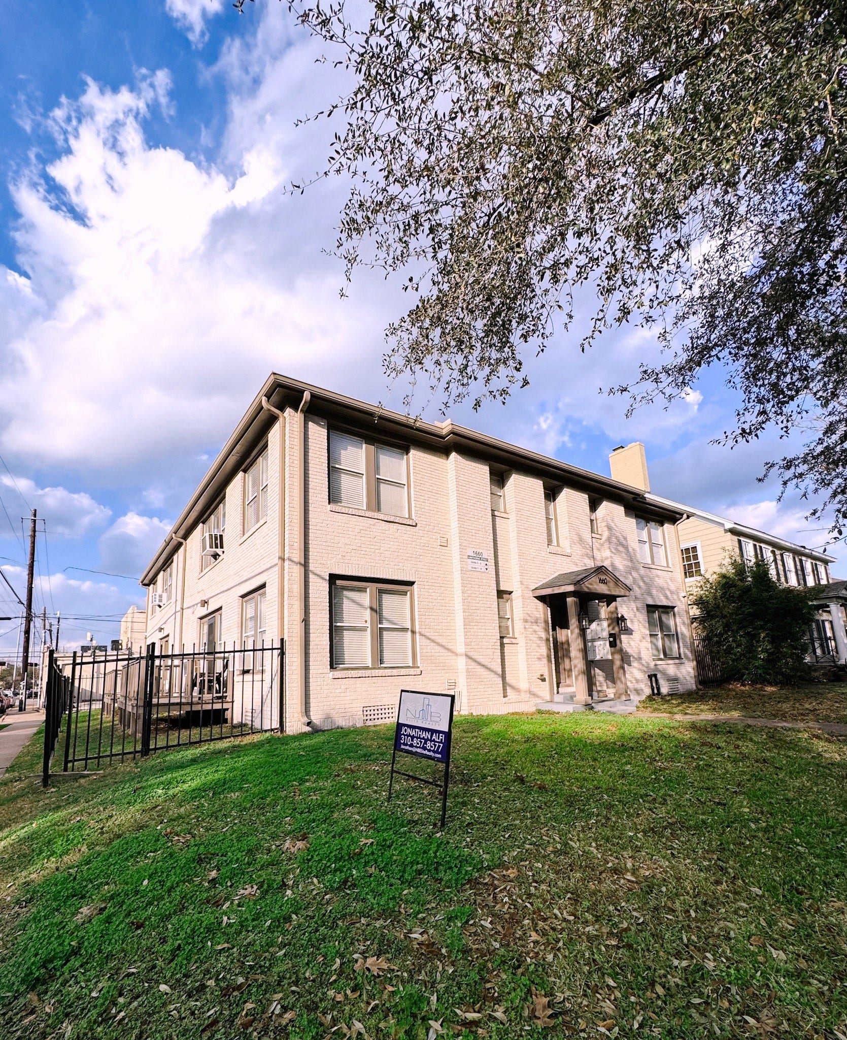 1660 Hawthorne Street, Houston, TX 77006 Angled exterior view of the eight-unit property highlighting the brick exterior, side elevation, fenced perimeter, and surrounding streetscape.