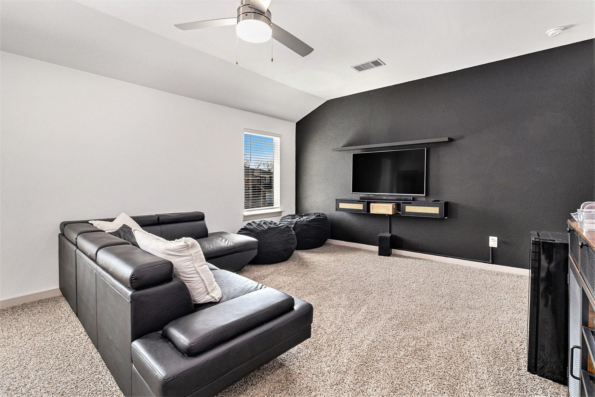 Spacious upstairs game room offers a second living area with plenty of room for movie nights, gaming, entertaining, or relaxing.