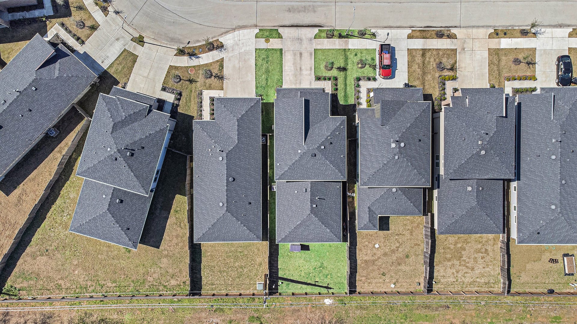 Aerial view highlighting the homes lot, fenced backyard, and position within the neighborhood. Photo taken prior to the addition of the deck and pergola.