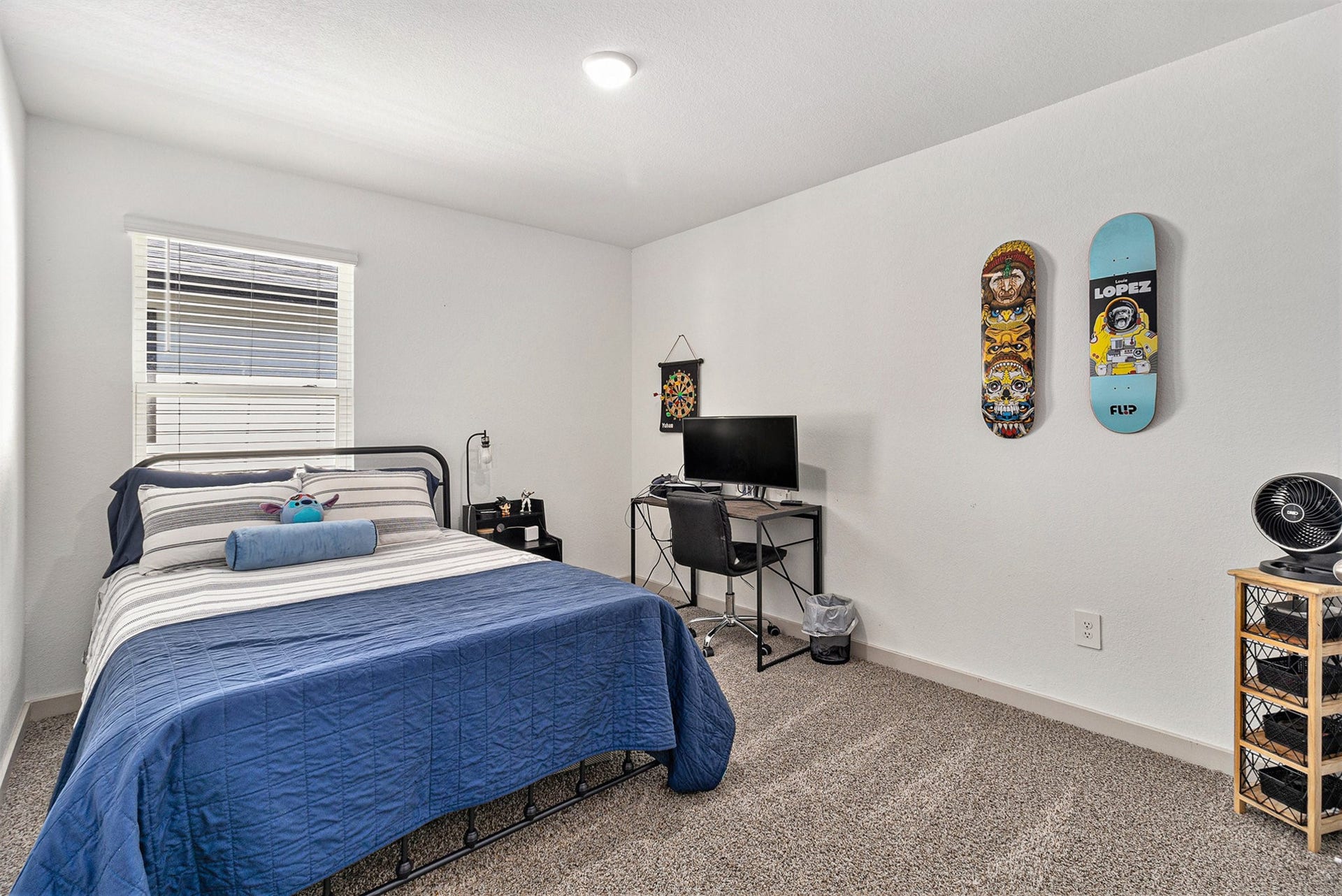 Spacious upstairs secondary bedroom with natural light and room for both bedroom furnishings and a desk or study area.
